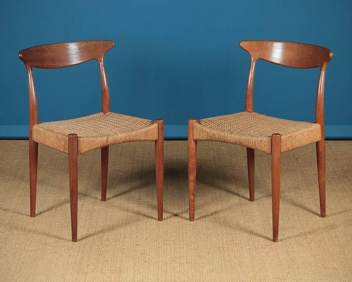 A really good looking set of midcentury dining chairs by Arne Hovmand Olsen circa 1960. Incorporating two slightly different designs to the backrests, six chairs and one carver all by Arne Hovmand Olsen for the Danish furniture makers Mogens Kold.