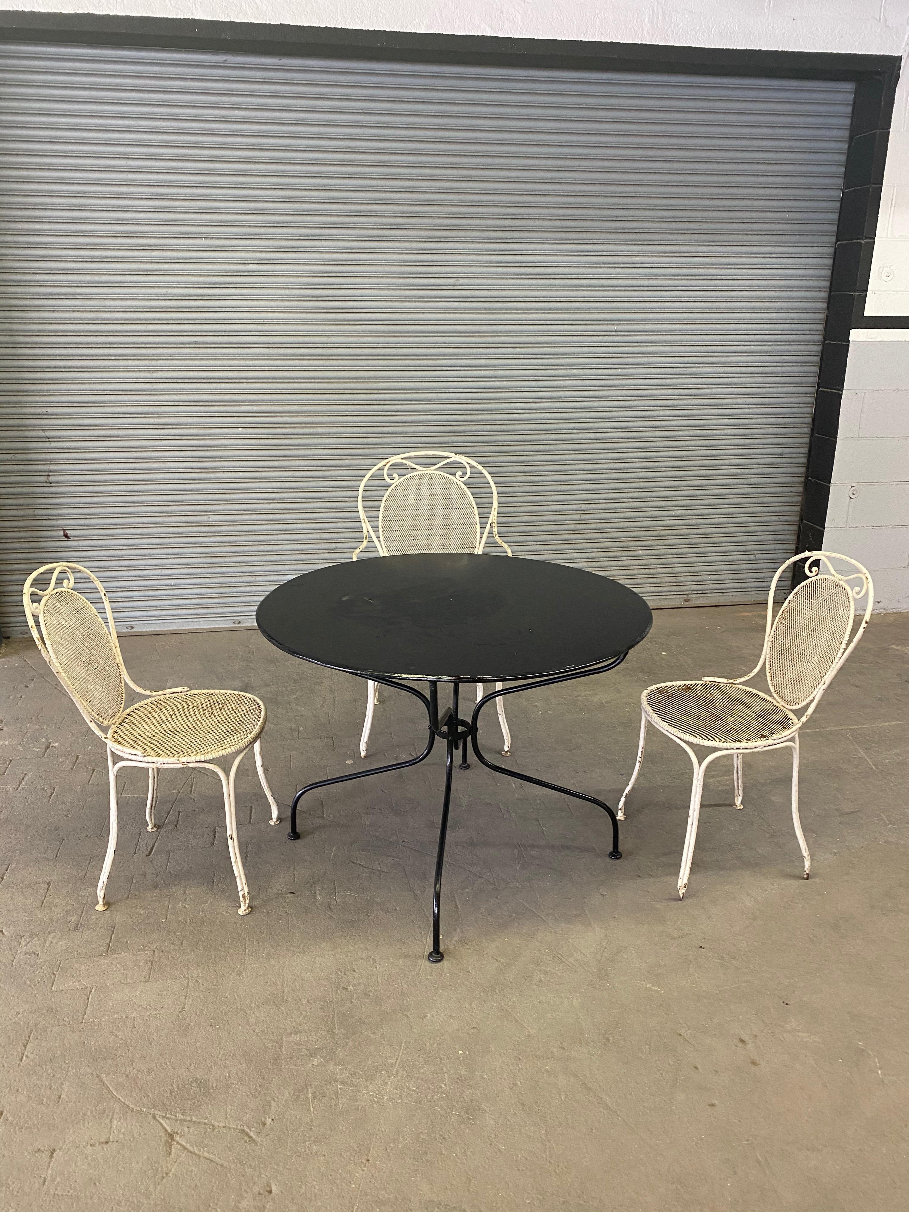 A set of seven French iron garden chairs in the original distressed paint finish. Consists of two armchairs and five side chairs. Sold as is. 

Measurements listed are for the side chairs. the dimensions for the armchairs are 37 H x 20.5 W x 21 D x