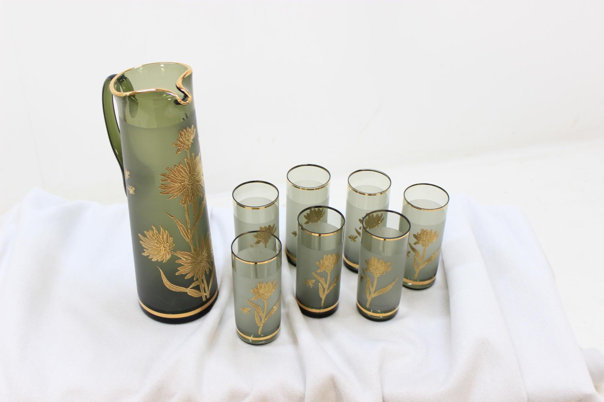 The items made of enamelled, and gilded green glass. On items are slices of gold. Dimensions of goblets 14x6x6 cm. are The set made in Czechoslovakia. Original condition.
