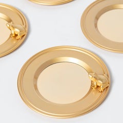 Set of seven gold metal coasters with frogs. France, Mid-20th Century.