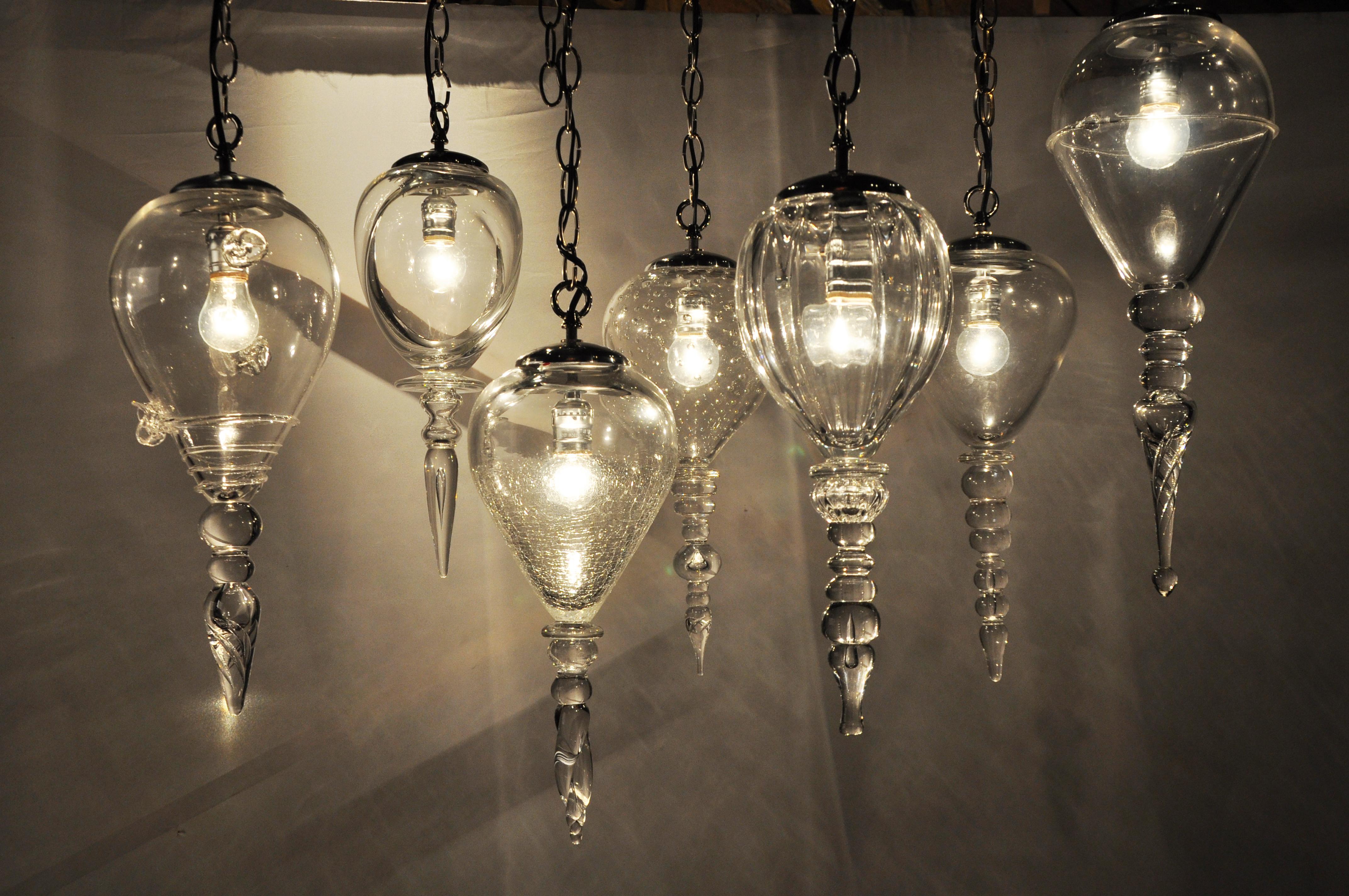 These elegant handblown glass pendant lights were made here in Chicago. They have been grouped together as shown and price is for the set of seven. They can be sold individually as well. Sizes and design varies between each pendant. They have been