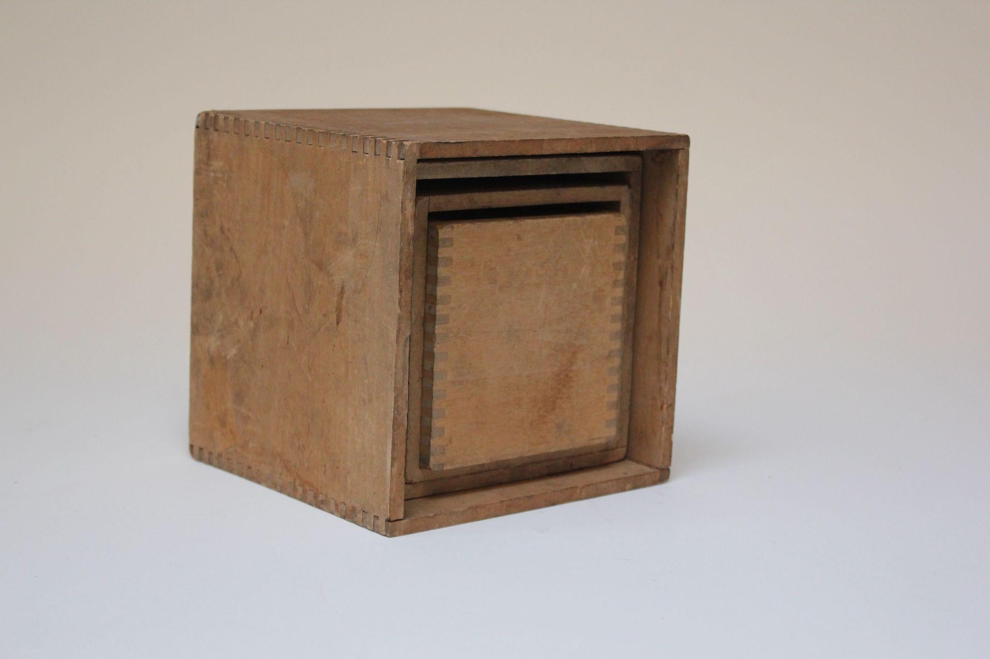 Primitive set of seven blocks and boxes (some four-sided, some two) which nest in the largest box (ca. early 20th Century, USA).
Thoughtfully crafted with finger jointed-edges and unique design details.
More complex assembly than a typical nesting