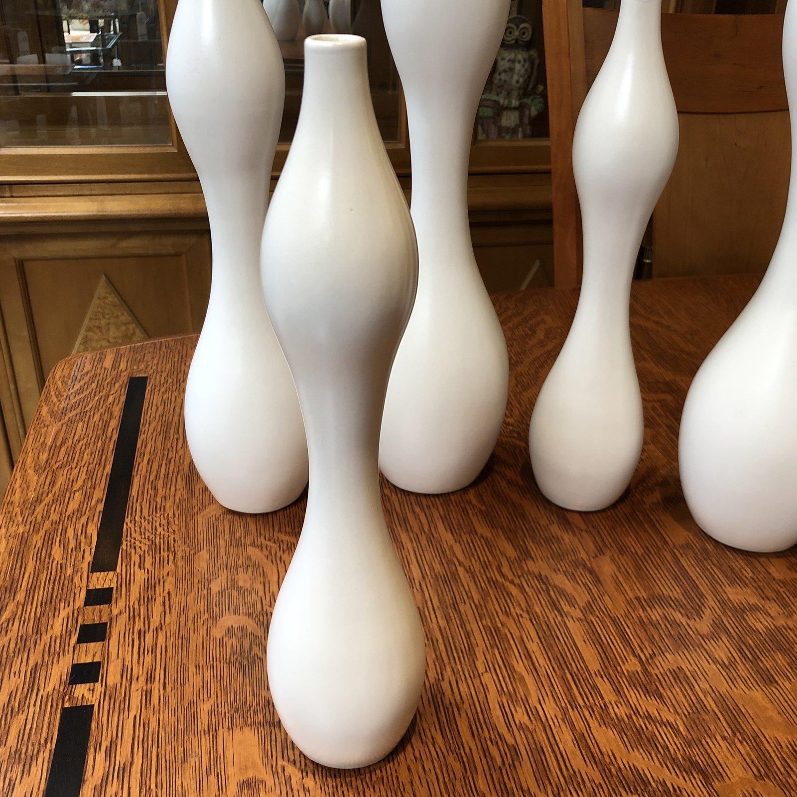 A collection of vases from Jonathan Adler. An undulating multi-height set of seven, these beautiful vessels are immediately identifiable as Jonathan Adler organic designs. Measures: Two are 18