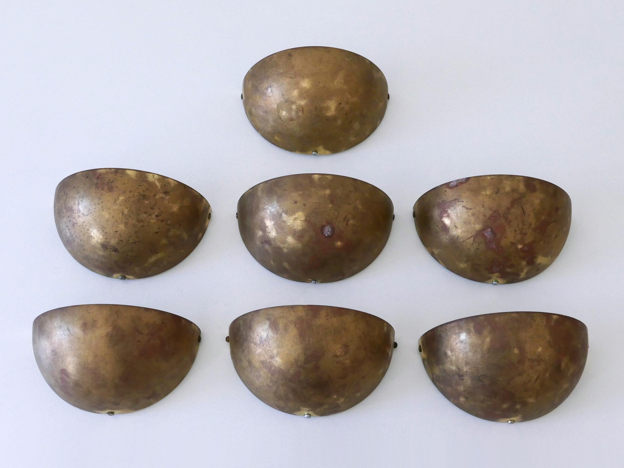 Set of seven rare and elegant Mid-Century Modern sconces / wall lights. Manufactured by Bankamp Leuchten, Germany, 1950s. Manufacturer's label inside the lamp shade.

Executed in brass and metal, each lamp comes with 1 x E14 / E12 Edison screw fit