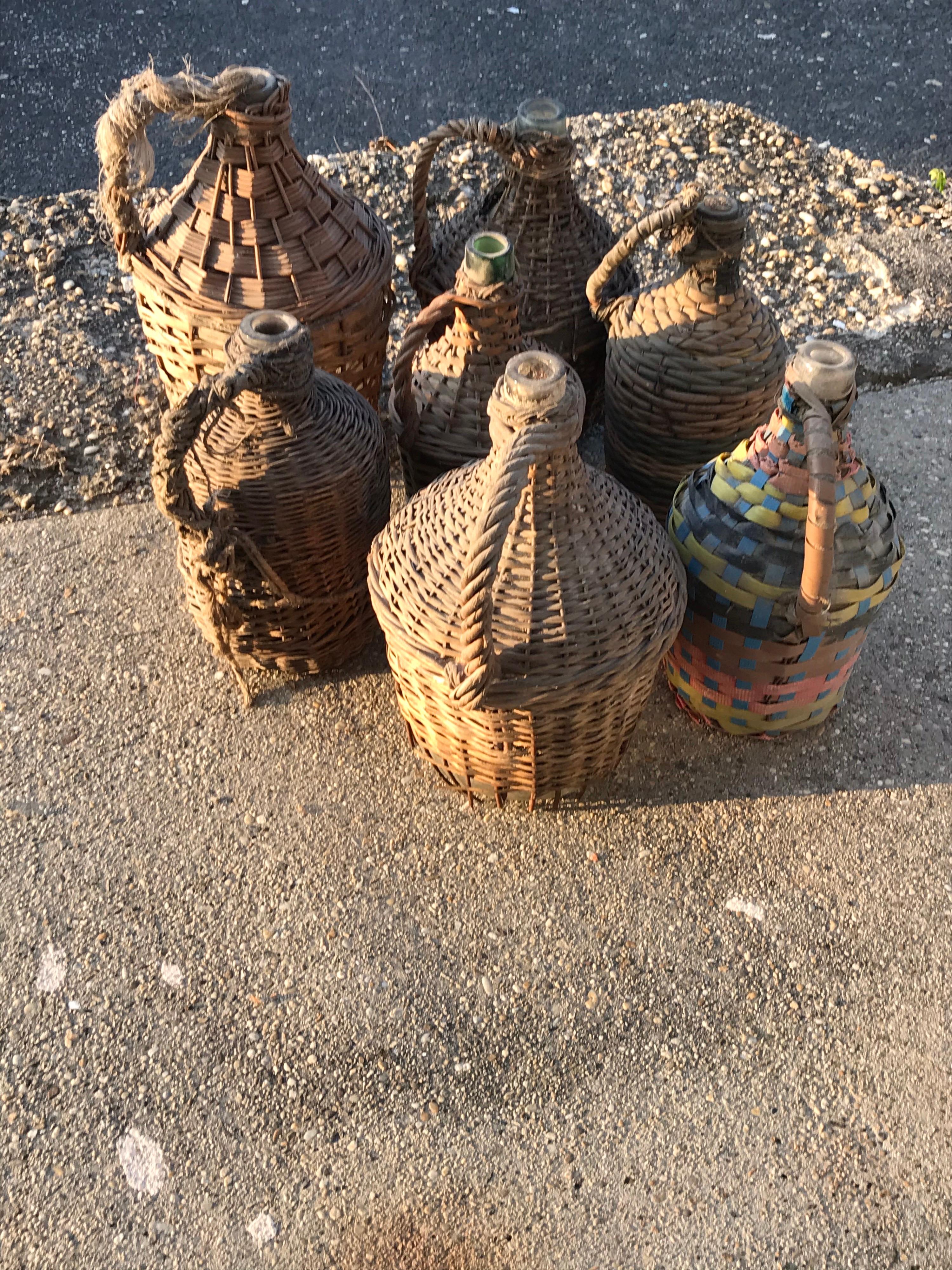 Set of seven midcentury vintner woven baskets with demijohn wine bottles
Each basket is nicely aged with lovely patina and show of age and use.
Size large: 20Q40H
small: 16Q32 H.