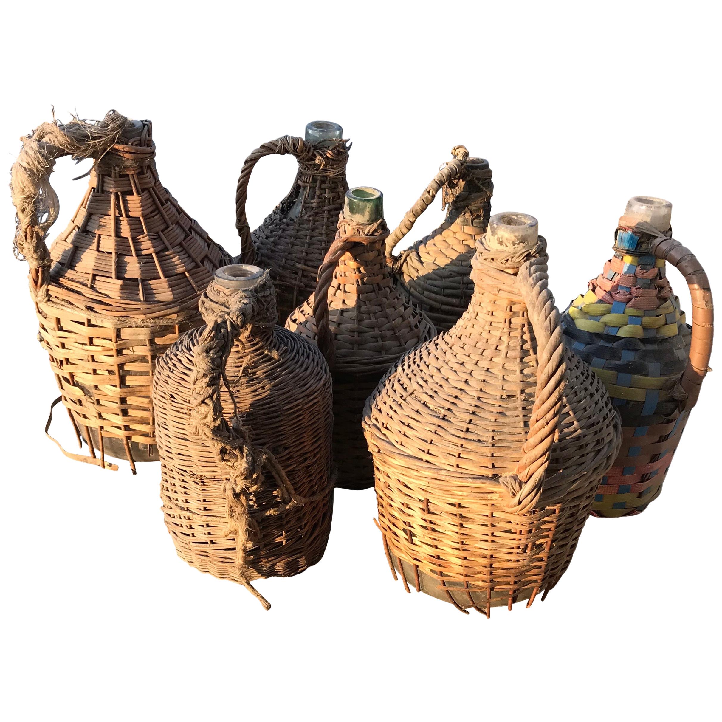 Set of Seven Midcentury Vintner Woven Baskets with Demijohn Wine Bottles For Sale