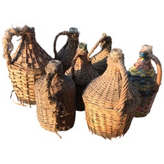 Vintage Set of Seven Midcentury Vintner Woven Baskets with Demijohn Wine Bottles