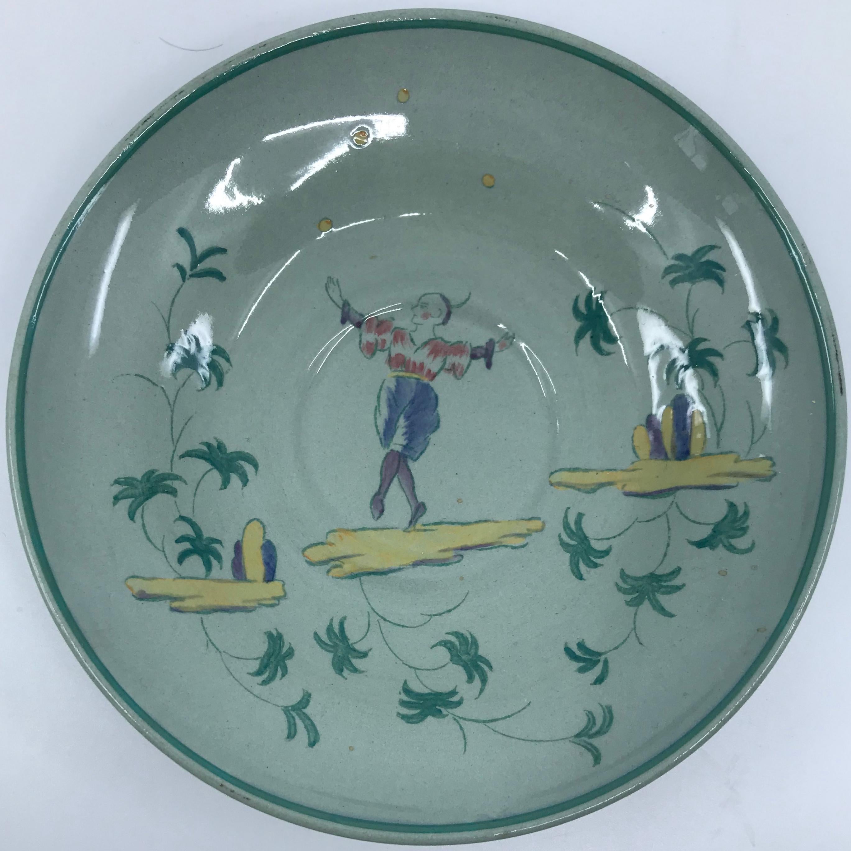 Set of seven Wedgwood Apprey celadon saucers. Seven saucers/small plates in the rare Apprey pattern of the early 20th century in pale celadon featuring a charming juggling chinoiserie figure in pale reds, blue, green, purple and yellow. England,