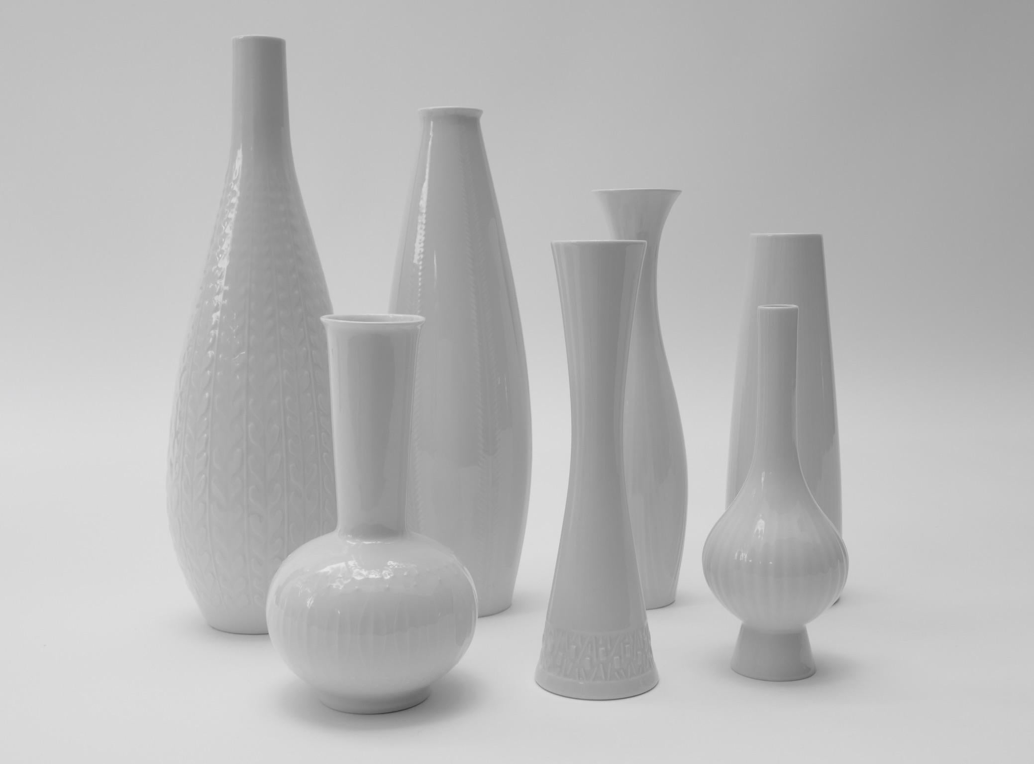 Set of seven white porcelain vases, Germany, 1970s

The measurements as seen on the picture 3 from the tallest vase to the smallest are :
H35 cm/ D11cm
H31cm/D9cm
H24cm/D7cm
H23cm/D7cm
H23cm/D4cm
H20cm/D8cm
H19cm/D11cm



