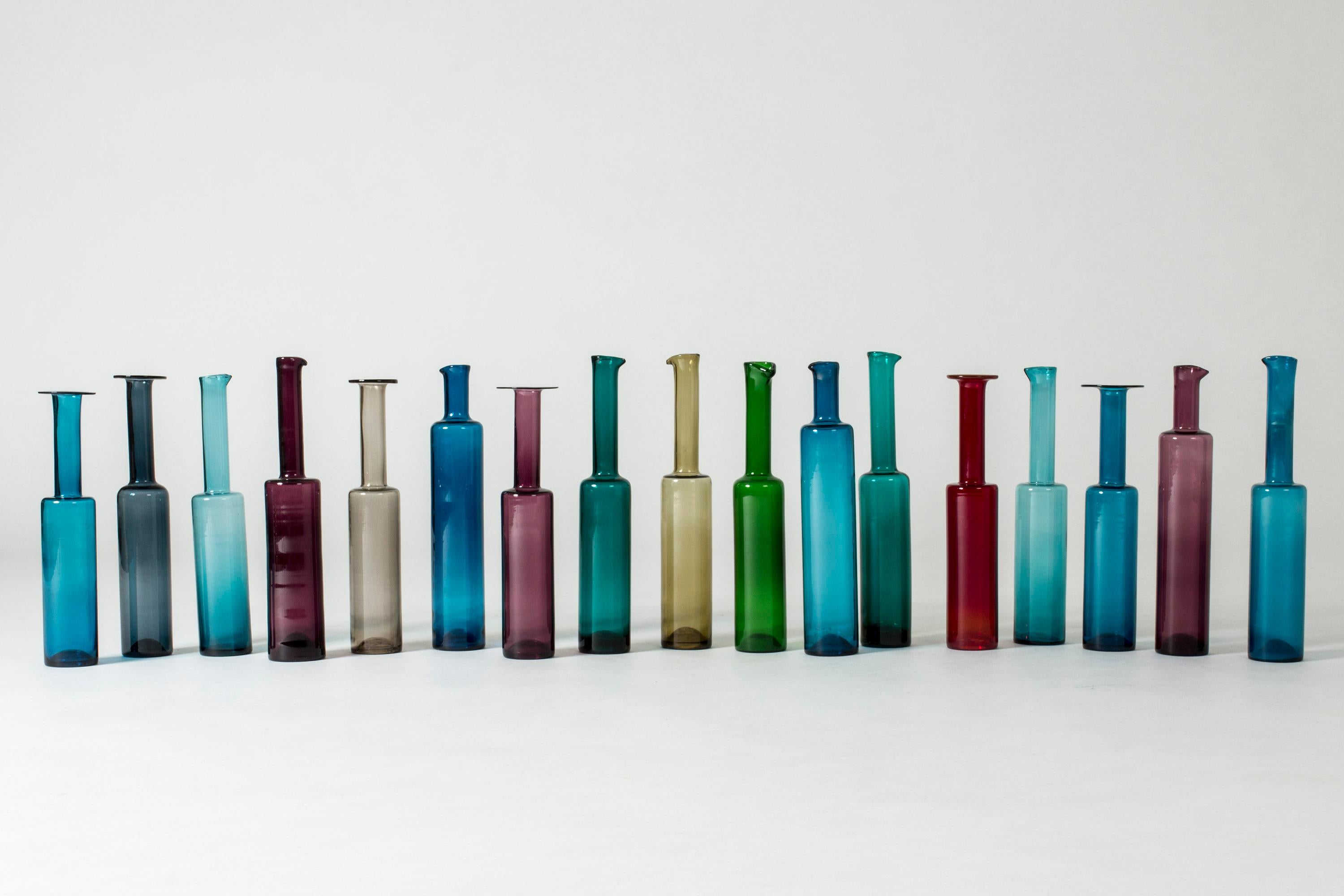 Amazing set of seventeen glass bottles by Nanny Still. Sleek, clean design with beautiful proportions, the simplicity and moderate colors giving them a strong yet tranquil presence. Six of the bottles have round wide brims and eleven have spots at