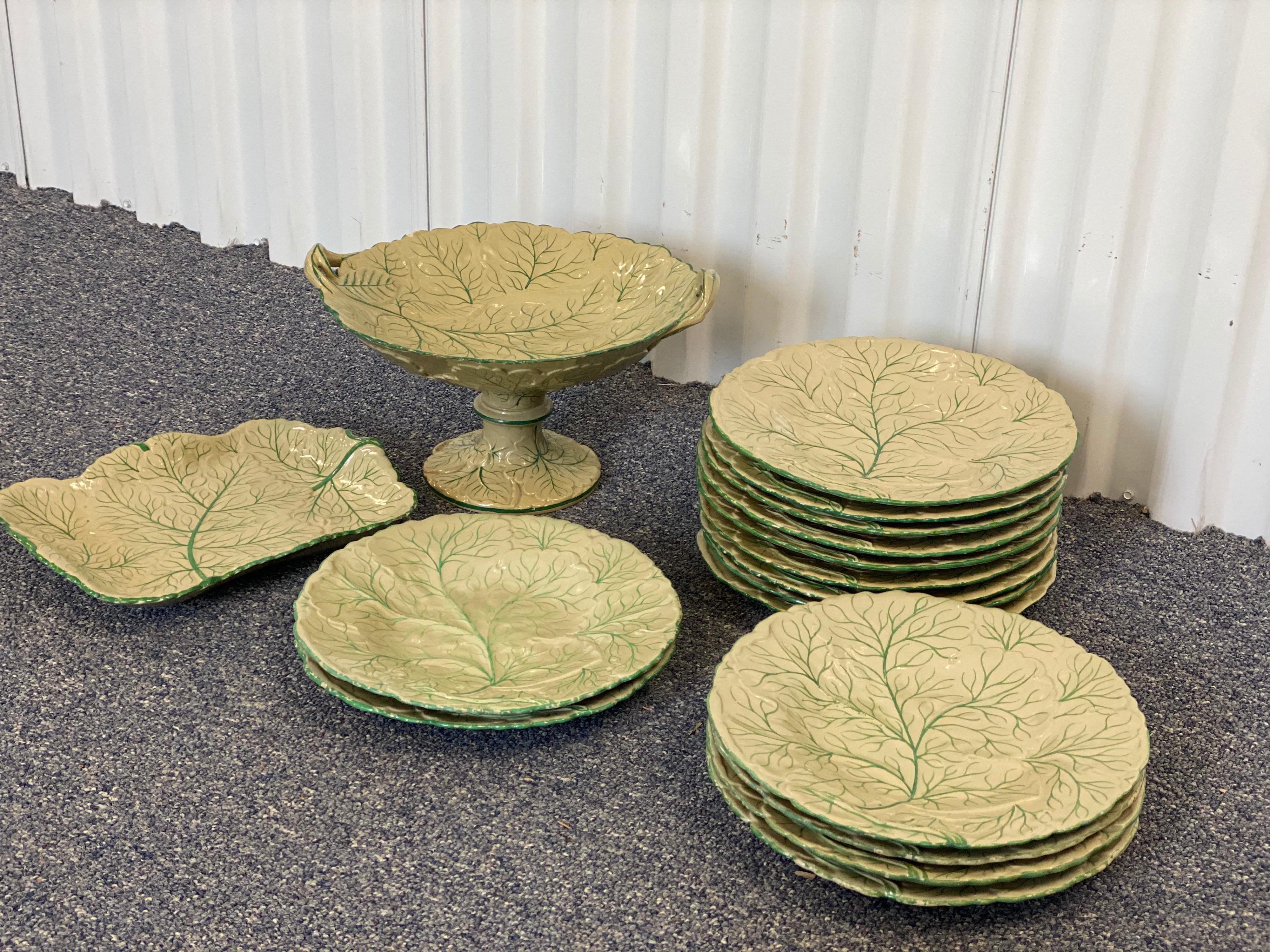 Leaf porcelain dessert set of 17 pieces includes 15 plates, one pedestal serving bowl, and one platter. This porcelain set boasts a lovely hand painted pattern mimicking the veins on a leaf or even that of a cabbage. The edges of the plates and the