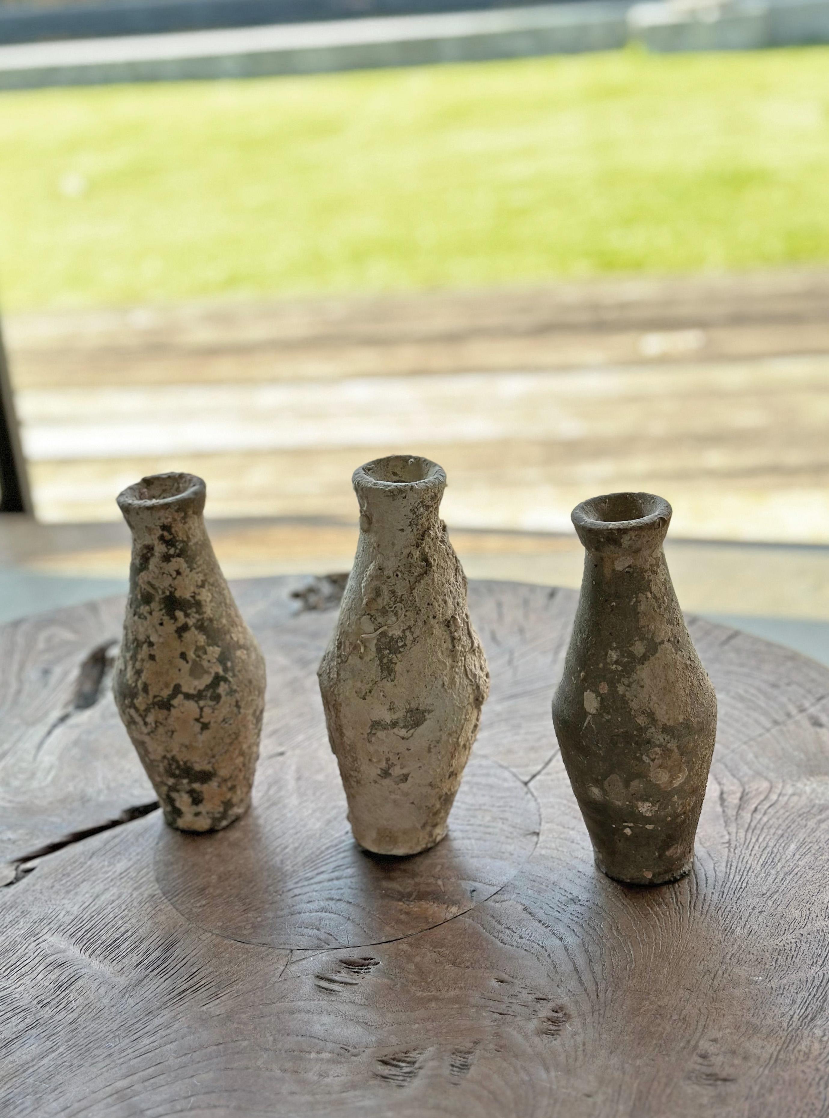 A set of 3 shipwreck bottles from a Shipwreck off the Coast of the Indonesian Island of Batam. Batam was one of the most substantial and influential ports in the South China Sea where an abundance of trade was conducted. This set of bottles feature