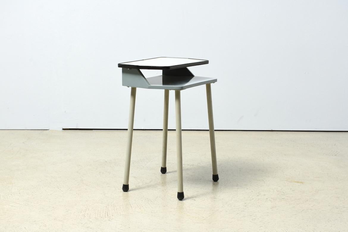Set of side table, small cabinet and chair. This lovely trio comes in a subdued industrial grey/blue tone. Lacquered plywood. Three-legged side table, four-legged cabinet with plastic surface. Attributed Netherlands 1960s. Only available as