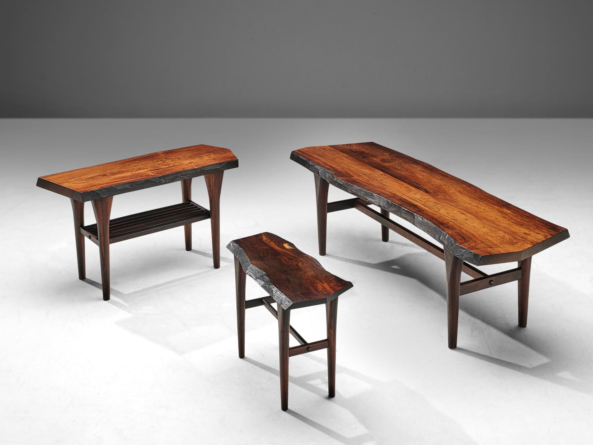 Set of side tables, rosewood, Denmark, 1970s. 

A set of three different sized side tables in beautiful free flowing forms of the wooden tabletops. The long and slender tapered legs give the tables an elegant look. Inspired on the natural style