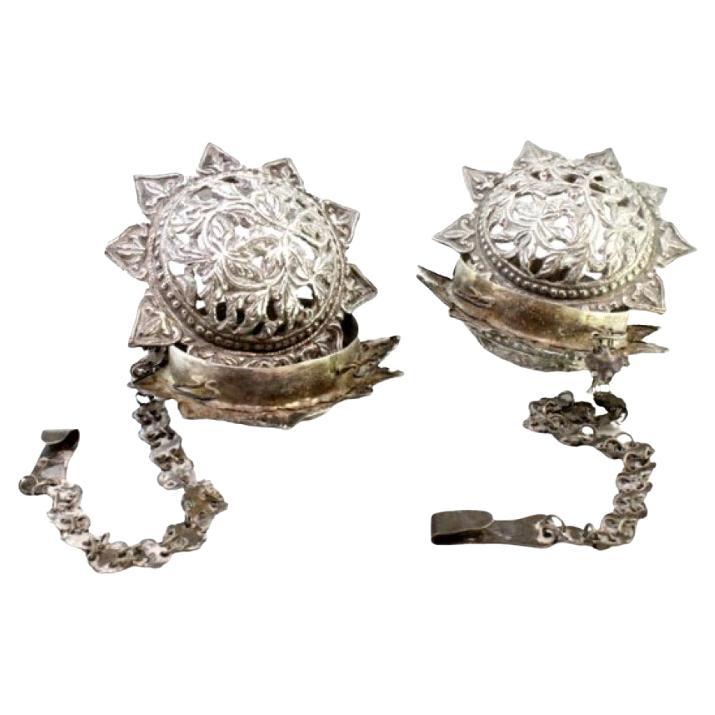 Set of silver air fresheners with reliefs and hanging chains