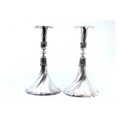 Set of silver candlesticks with embossed stems and cut-out sconces