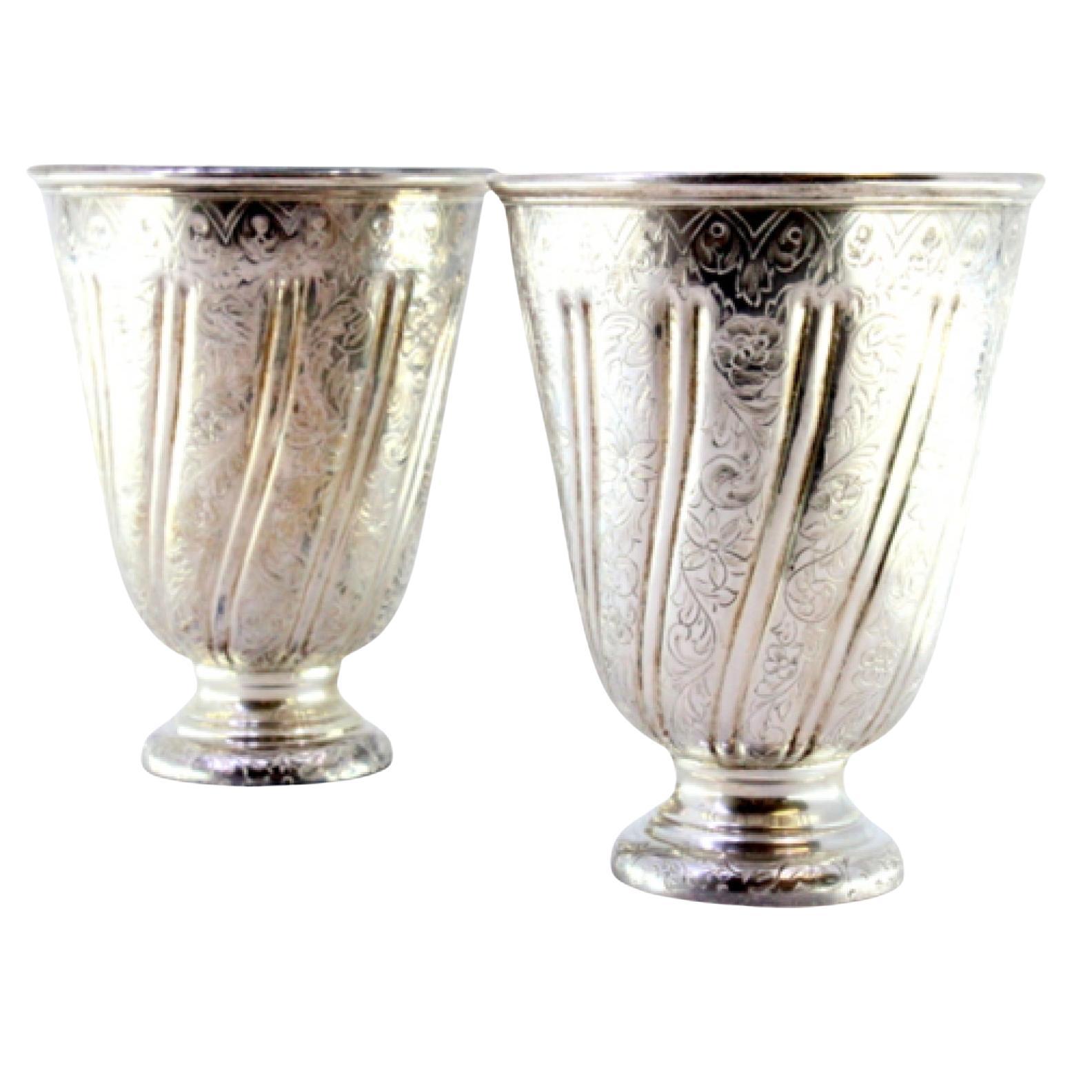 Set of silver cups with reliefs and friezes set on round bases