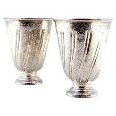 Set of silver cups with reliefs and friezes set on round bases