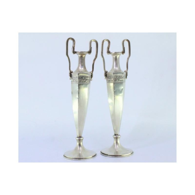 Description: Set of silver jugs with friezes on the structure and two raised handles. Metal: Silver. Origin: Portuguese. Brand: Absent. Weight: 170.32 grams (Set of two jugs). Dimensions: 5cmx19cm. Content: 833/1000. Assay Mark: Absent. Additional