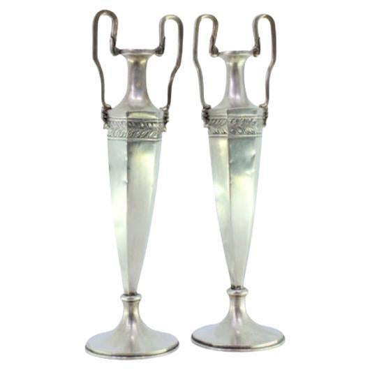 Set of silver jugs with friezes on the structure and two raised handles