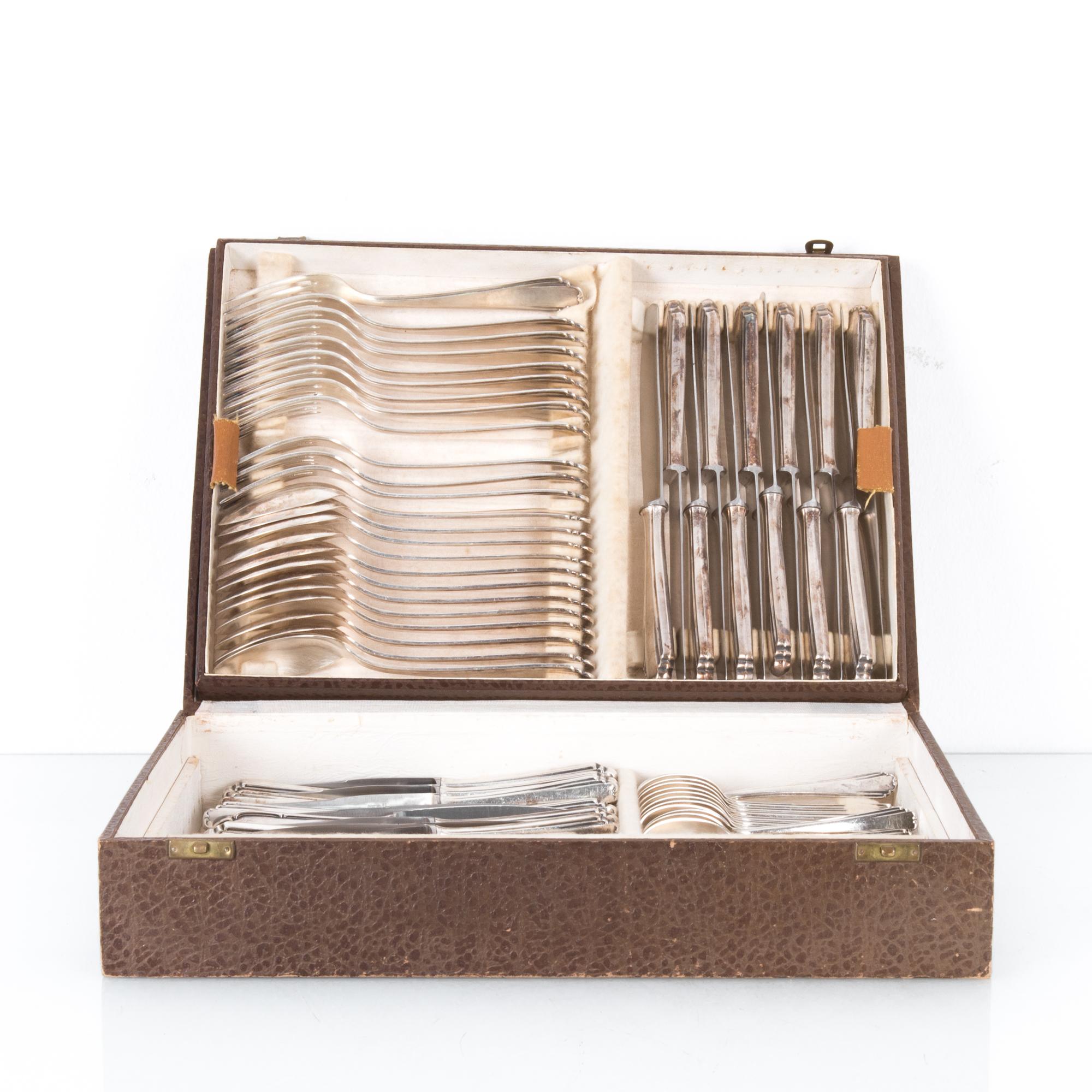 This set of silver plated cutlery was made in Belgium, circa 1900. The hinged, gray box opens to reveal an interior with four compartments and an additional two compartments in the lid. This 85-piece cutlery canteen will cater for a party of 12.