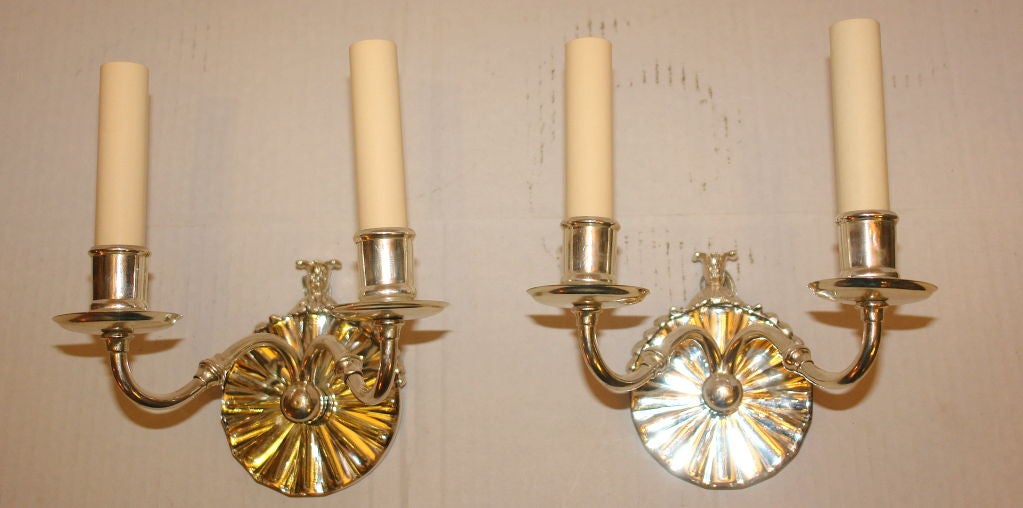 Set of ten circa 1920s French silver plated double light sconces with mirrored backplates. Sold per pair.

Measurements:
Height 5