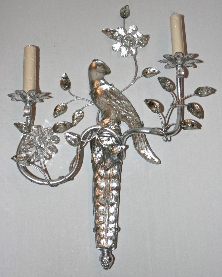 Set of four circa 1950's French two-arm silver leaf metal and molded glass sconces inn the shape of a parrot. Sold in pairs.

Measurements:
Height: 21.5