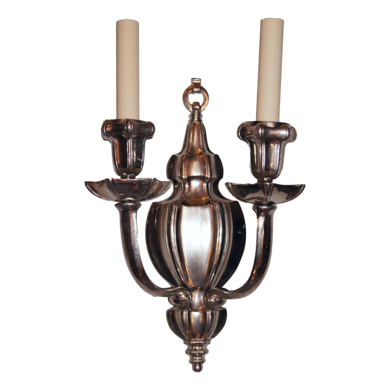 A set of eight American circa 1930s silver plated double-light sconces with original finish.

Measurements:
Height 13