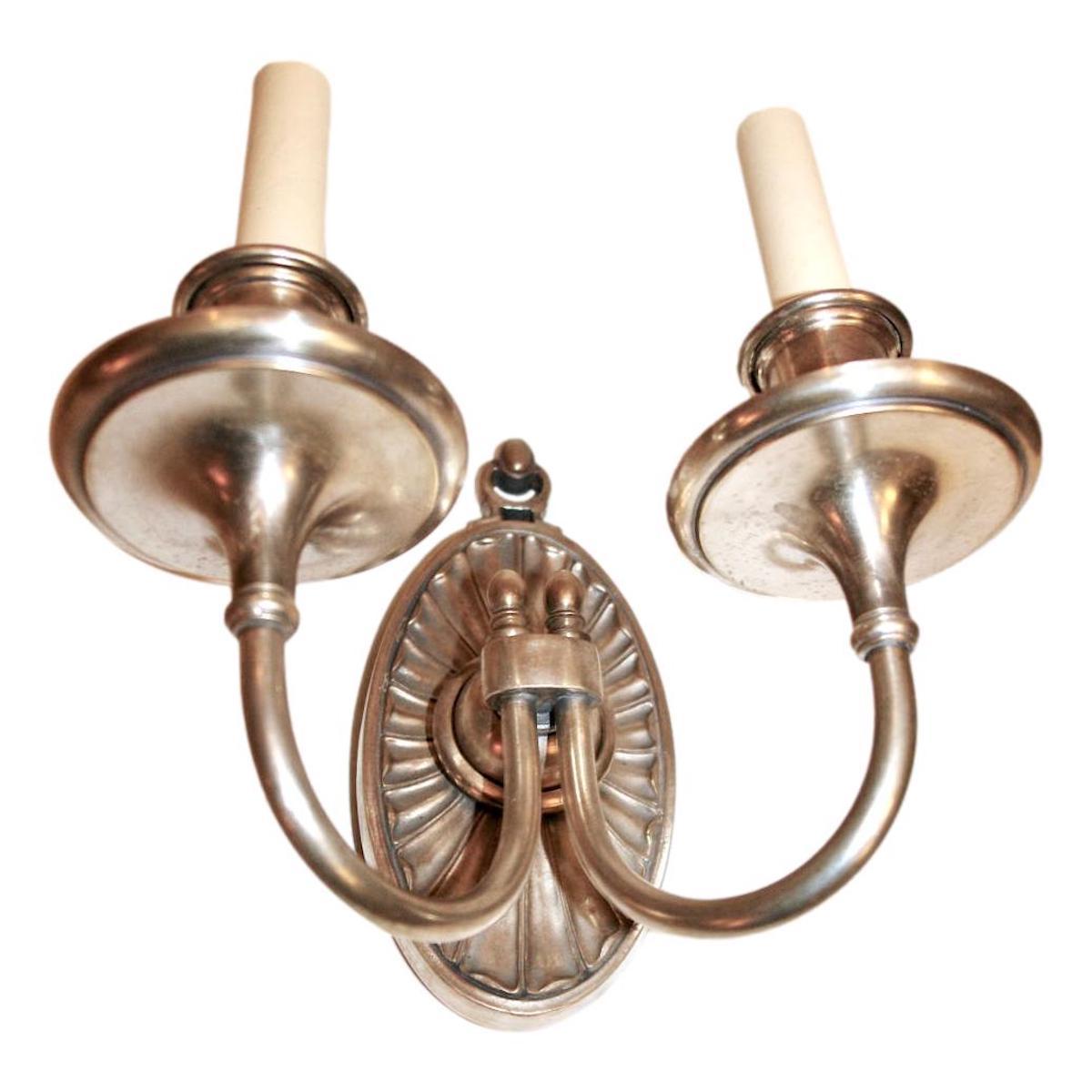 A set of 8 English, circa 1920s silver-plated double light sconces. Sold in pairs.

Measurements:
Height: 8