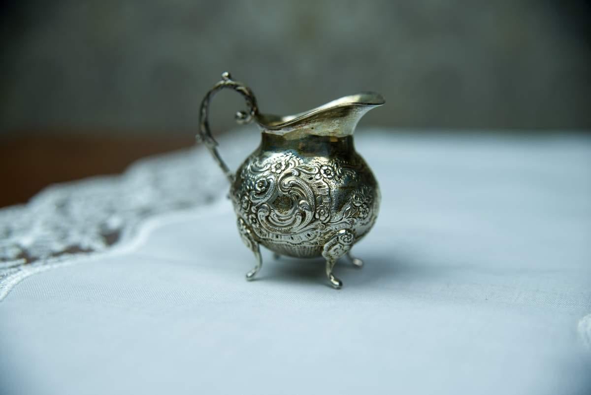 The items are entirely made of 0.835 silver with Swedish hallmarks. Weight: 230 grams.
The set includes a tray (16.5 x 10.5 cm), a small milk jug (height: 6.5cm) and a sugar bowl (height: 5 cm, diameter: 6 cm).
The vessels are ornamented with an