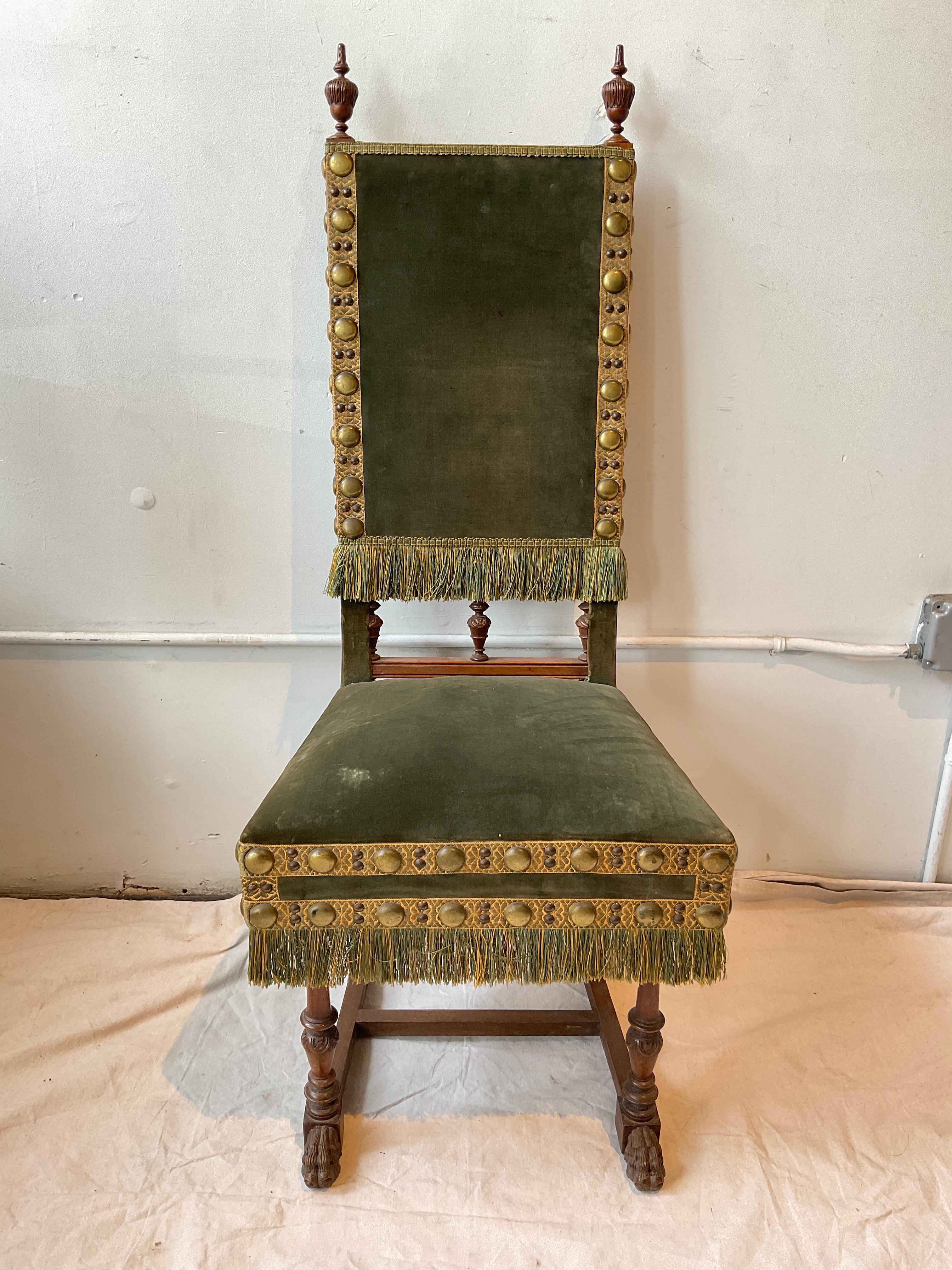 Set of six English lion paw dining chairs from 1900. Large brass nail heads. Some stains on velvet. 5 of the finials have some damage.