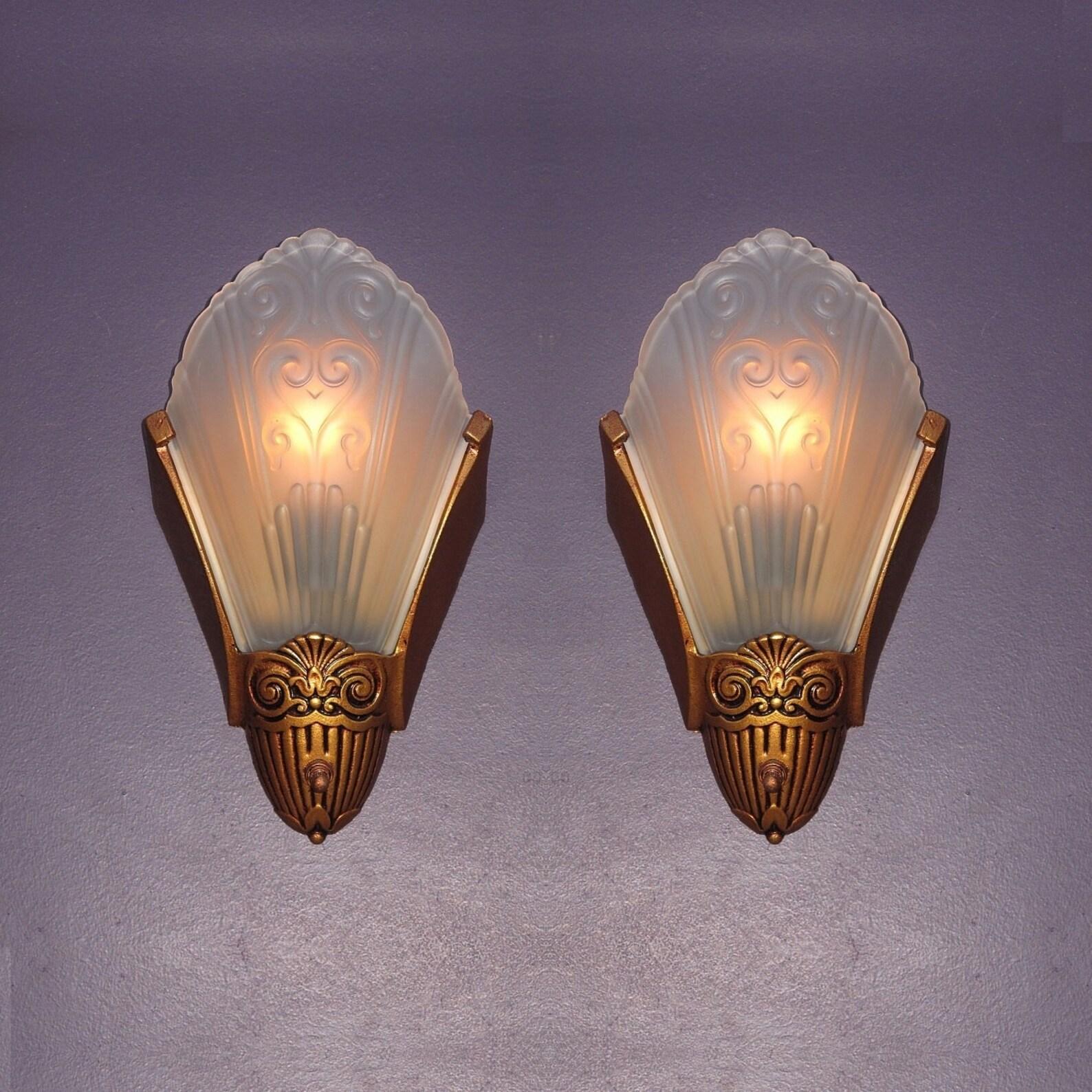 Simple yet elegant vintage slip shade wall sconces by Virden of Milwaukee. Dates to late 1920s through the 30s, the Art Deco period of American design.
Solid cast iron back with clear frosted shades and the fixture is refinished in an original