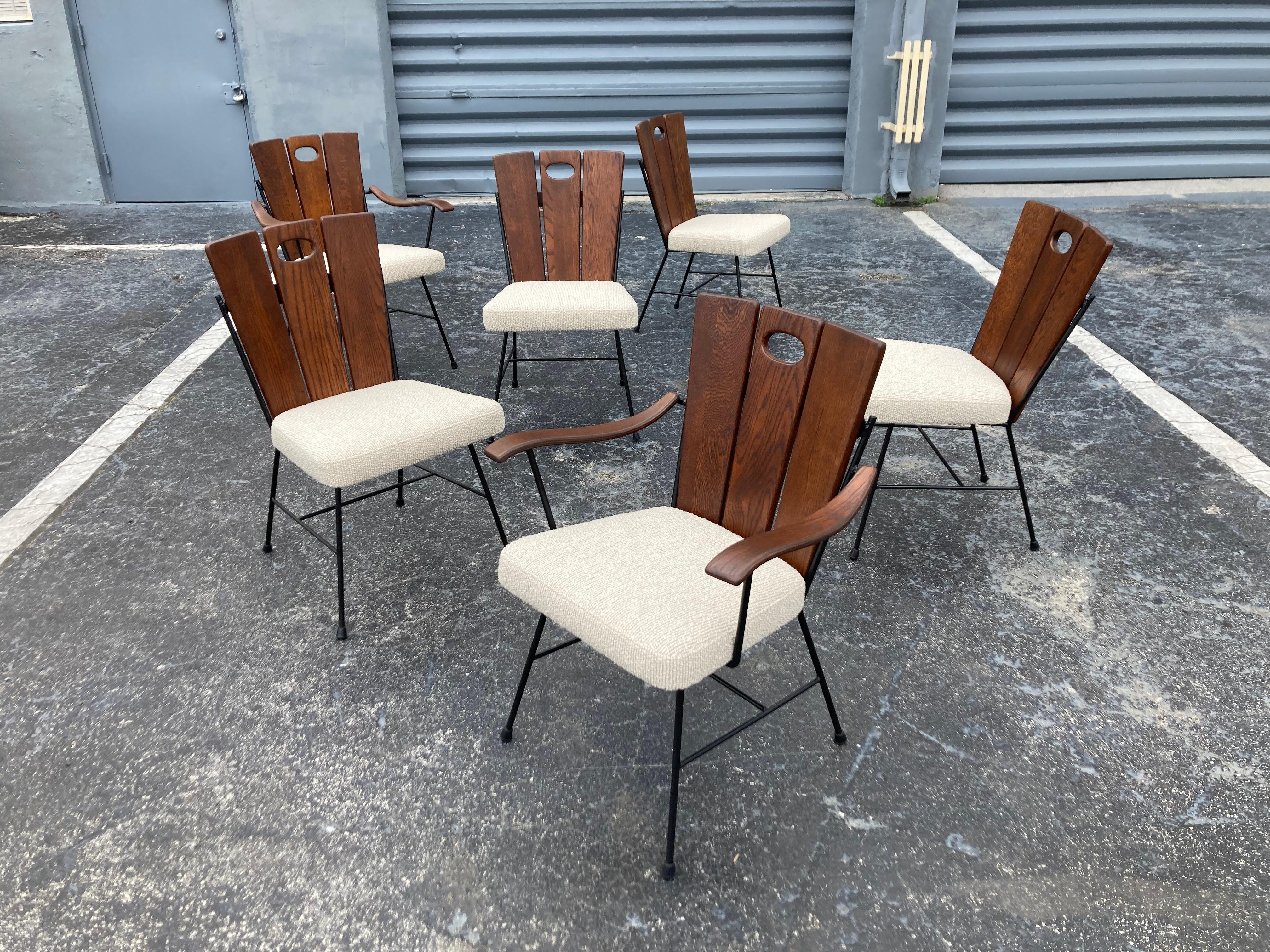 Set of Six 1950s Iron and Oak Dining Chairs. Four Side and Two Arm chairs. 
Black painted iron frames with solid oak backs. Seats have been recovered.
Arm chairs are 25.25 wide and the arm height is 24”.
Sturdy chairs and ready for a new home.