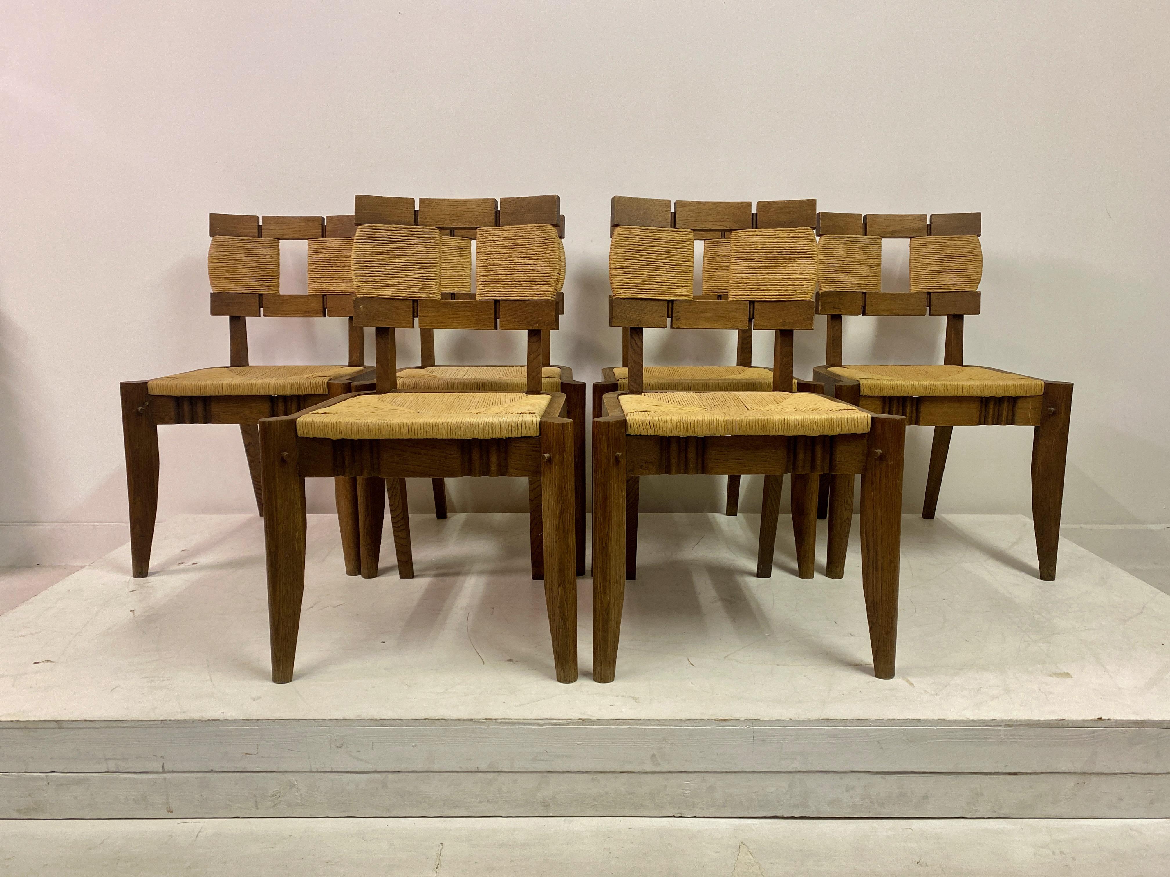 Set of Six Dining Chairs

Oak frame

Rush seat

Possibly by Victor Courtray

France 1950s