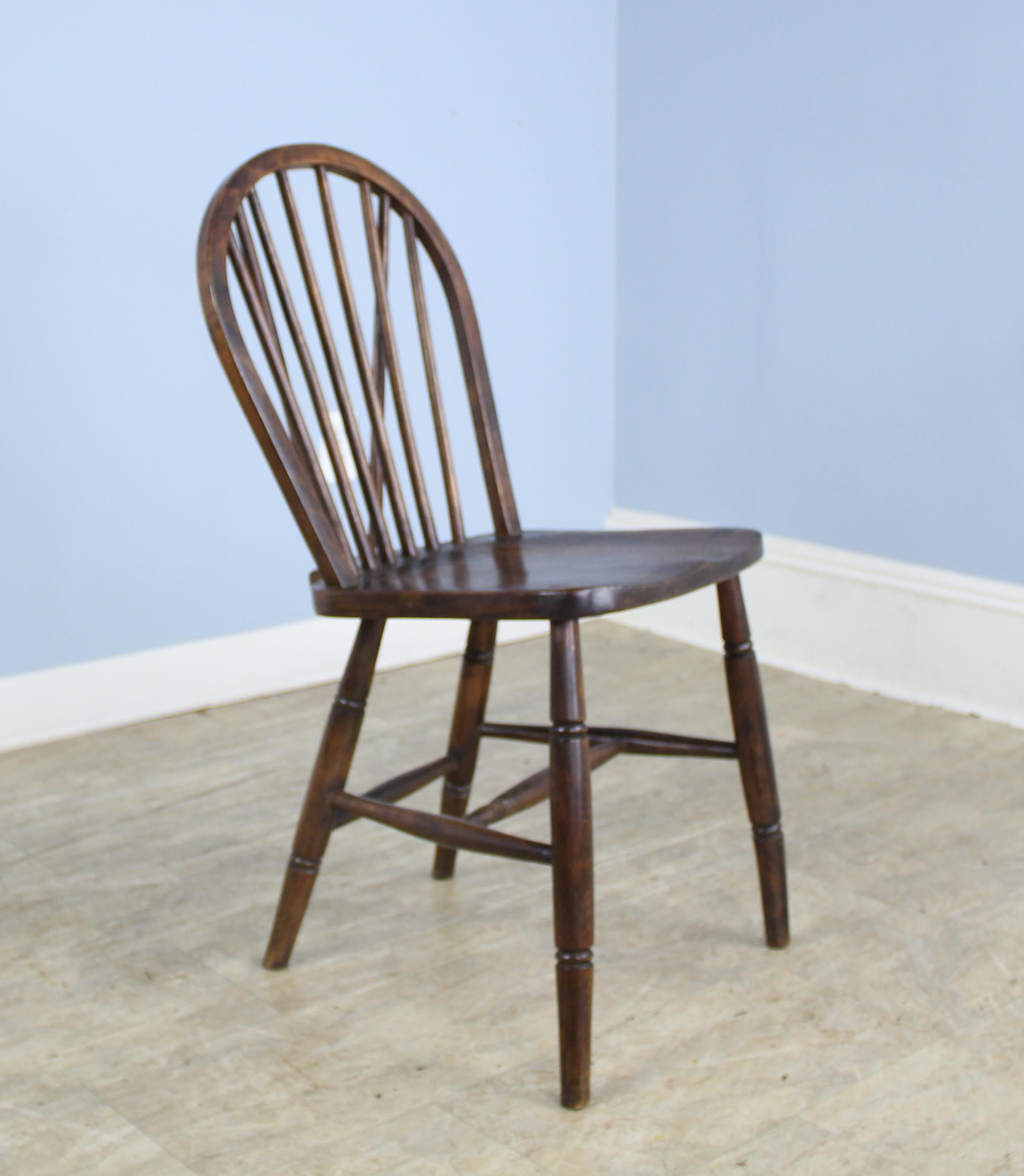 A set of six English elm Windsor chairs in very good antique condition. Although this is a like set, they are handmade, and the legs have slightly different flare, as shown in image #5. These would look wonderful around any number of table styles.