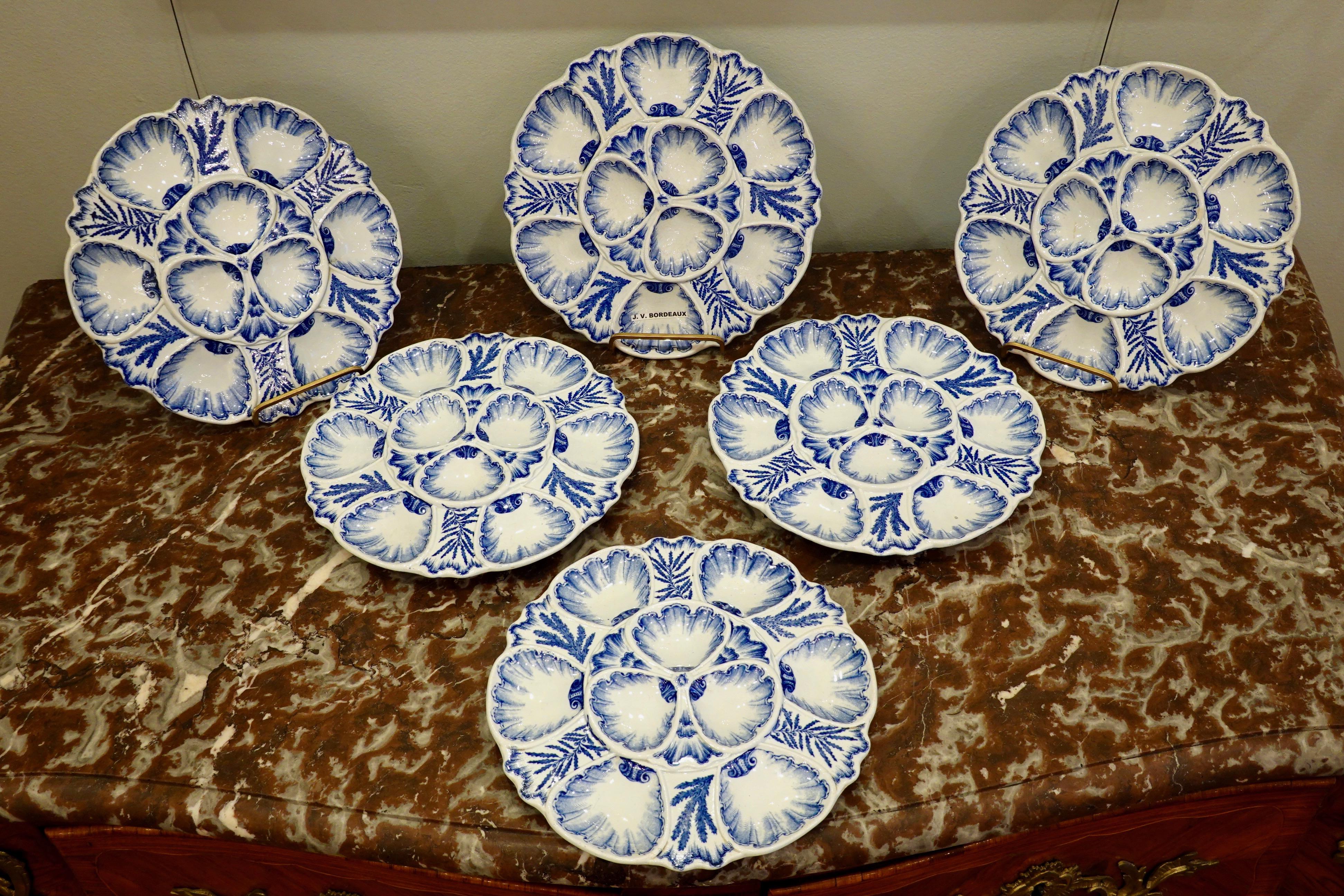 Set of six highly-decorative blue and white French faience oyster plates stamped 