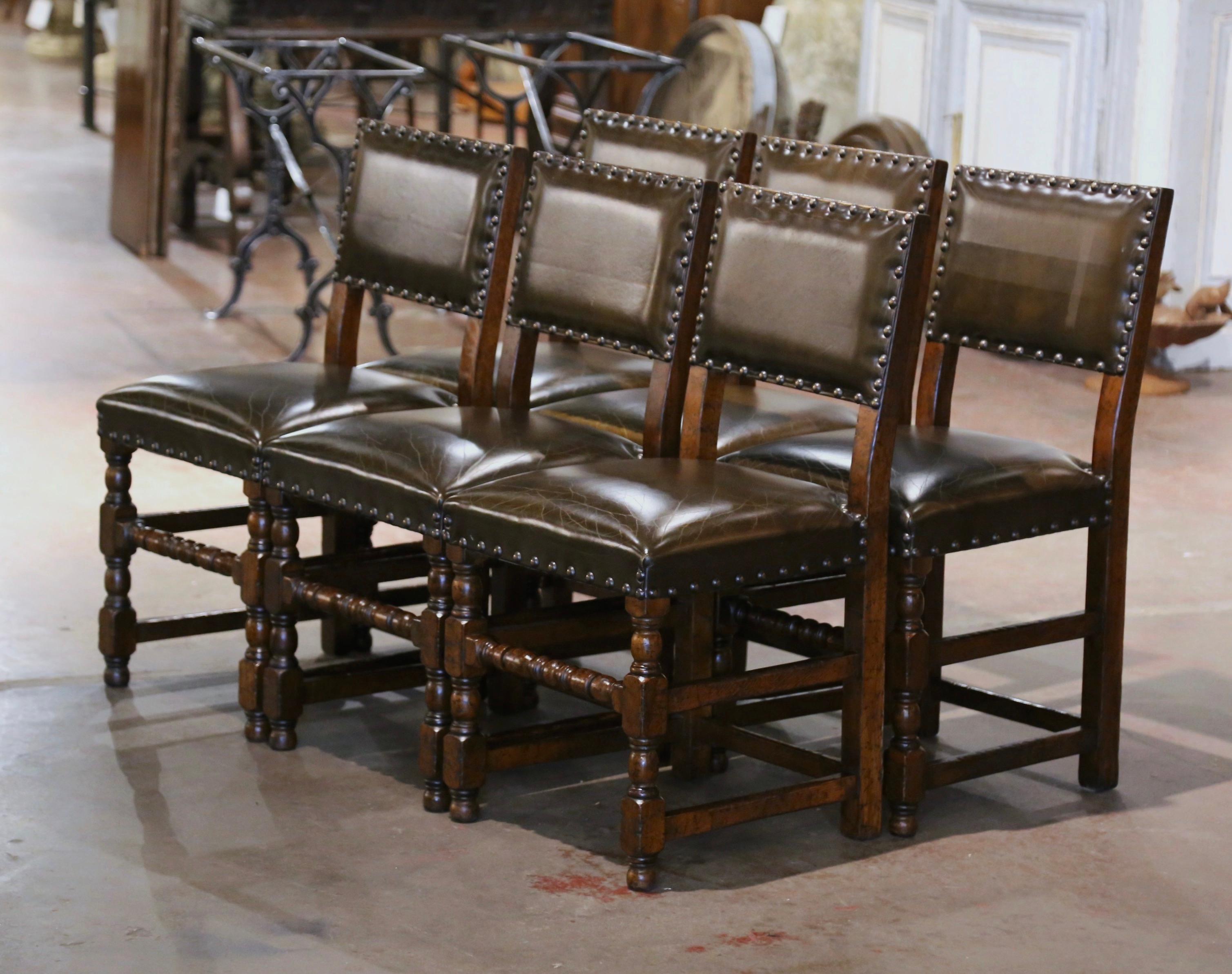 Decorate a breakfast room or game room table with this elegant set of antique chairs. Crafted in southern France circa 1880 and built of solid oak wood, each sturdy chair stands on turned legs ending with round feet and connected with a double