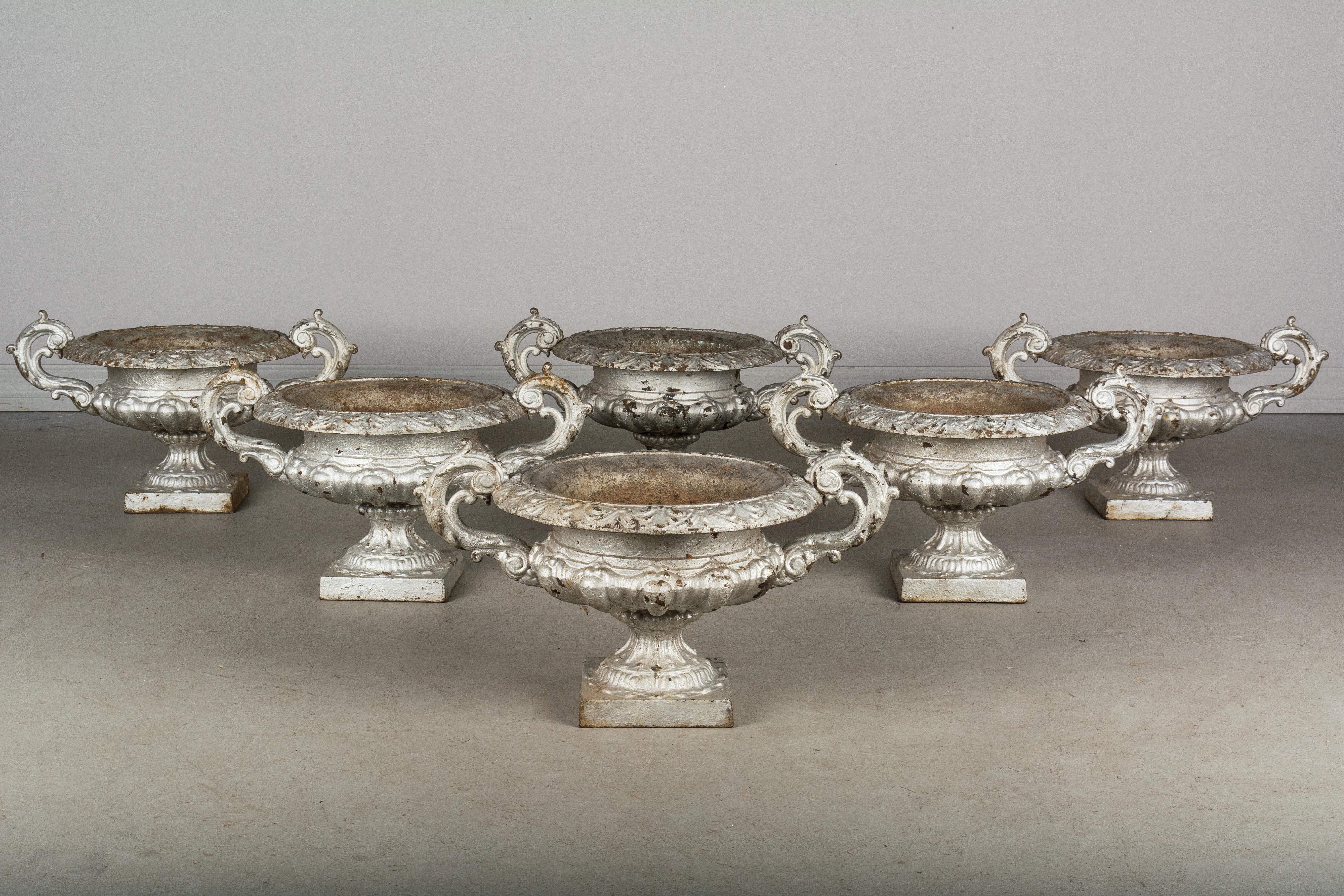A set of six 19th century French cast iron garden urns, or planters with weathered silver painted patina.
Weight: 22 pounds each. Measures: Overall: 20.5