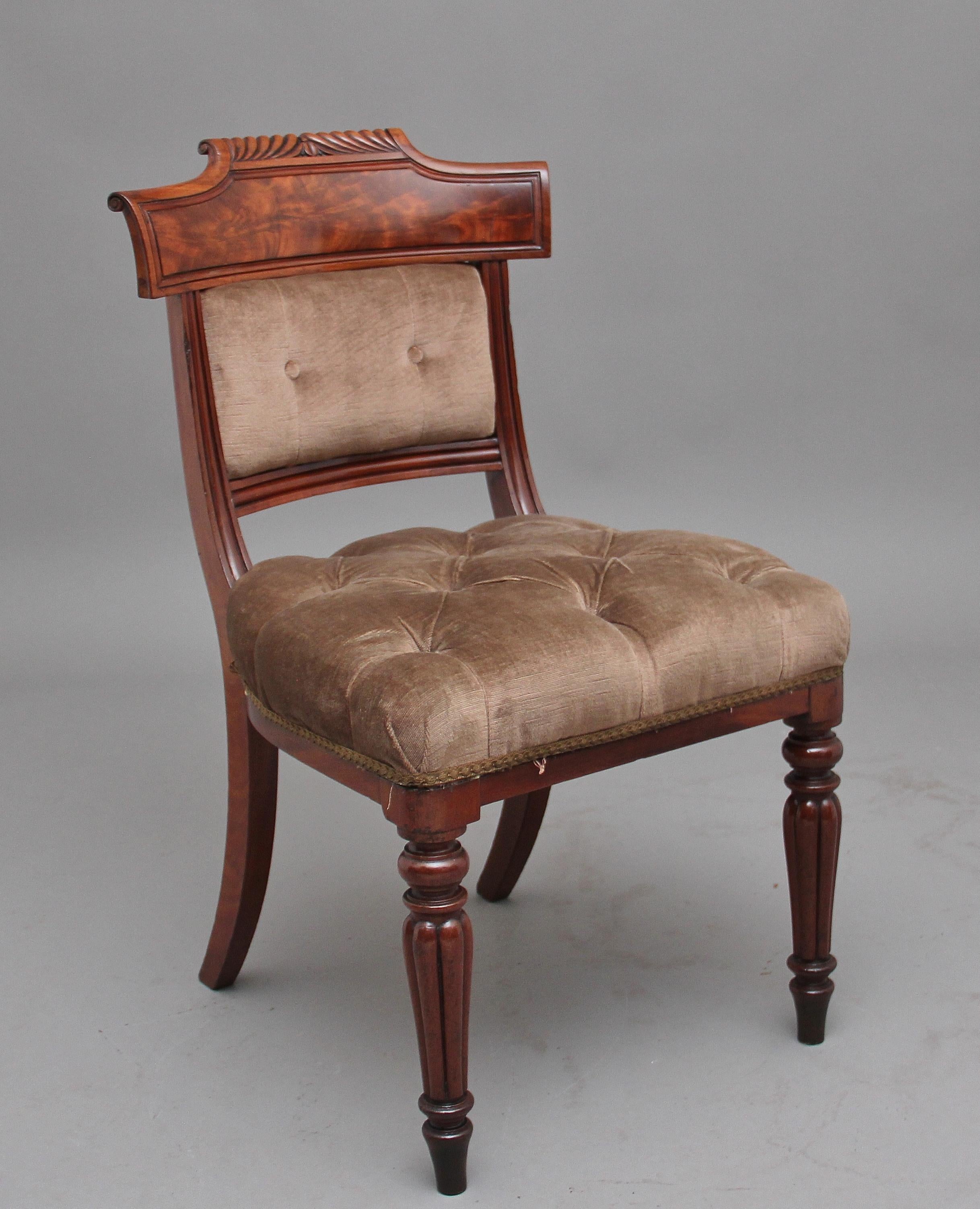 A set of six 19th century mahogany dining chairs, the carved and shaped top rail with reeded rails below enclosing cushioned padded backs, the cushioned upholstered seats in the same off gold colour as the padded backs, standing on rear outswept and