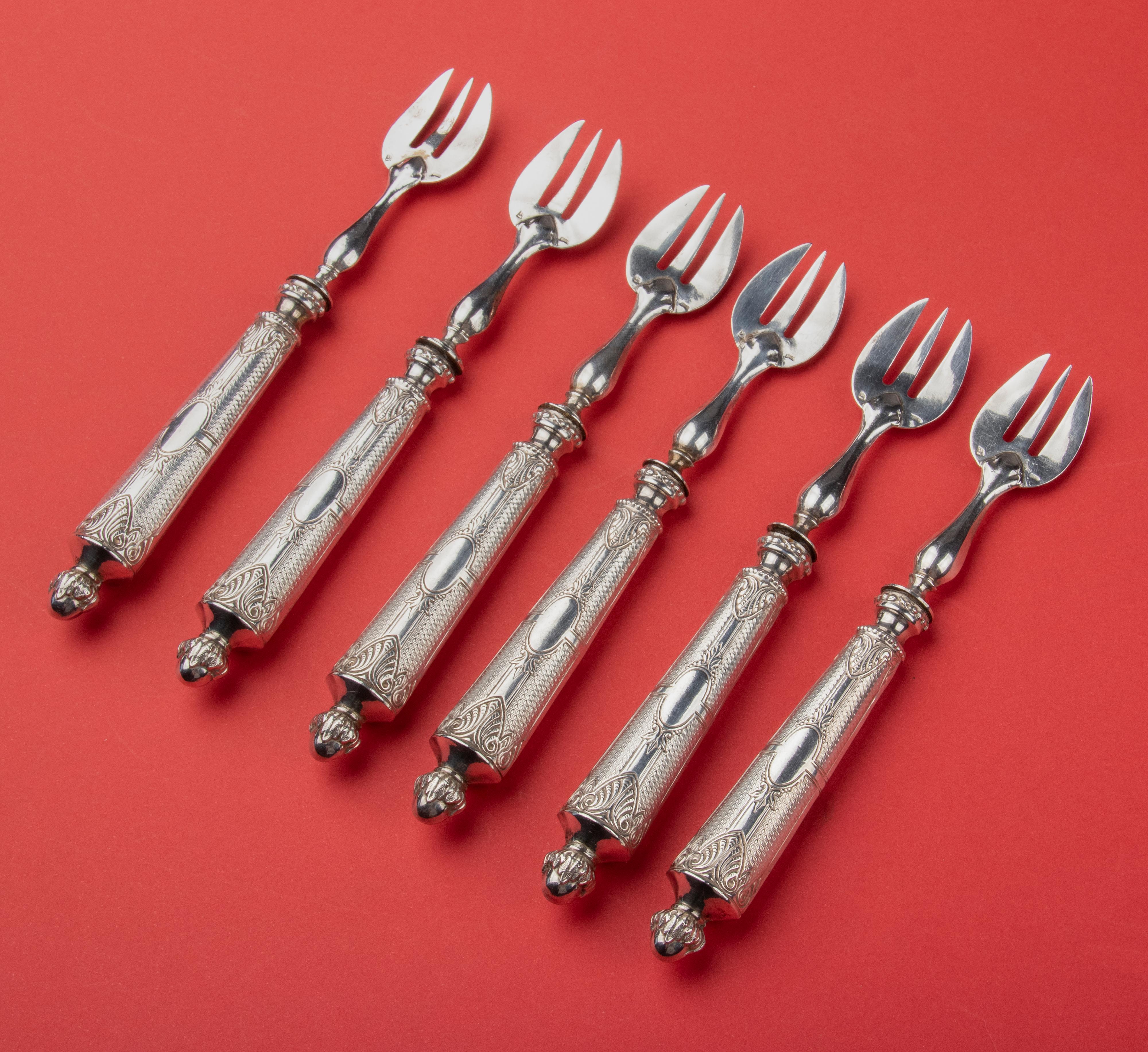 Beautiful set of six antique silver oyster forks. The forks have thick handles, making them easy to handle. The have elegant ornamented finish. There are silver marks visible, but not very legible. The forks have been tested and are shown to be