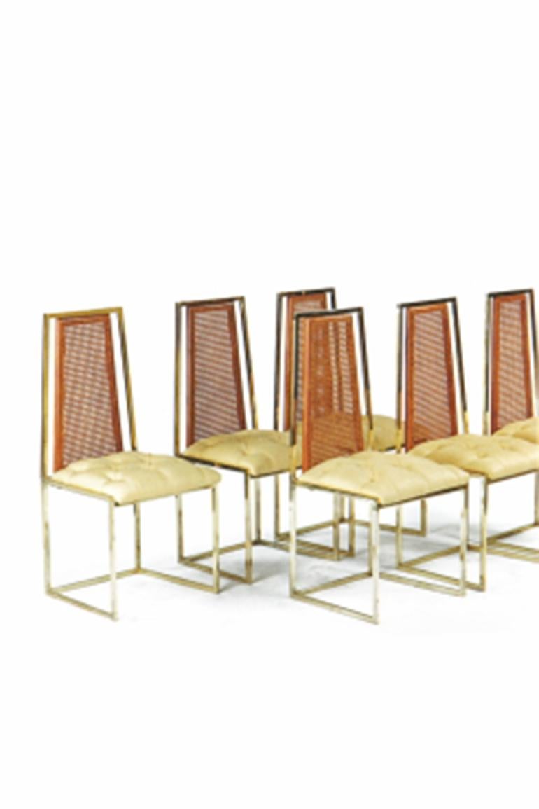 A set of six 20th century brass and beechwood dining chairs atributted to Milo Baughman. The spreading rectangular caned back above a padded seat covered in yellow linen,
circa 1970.