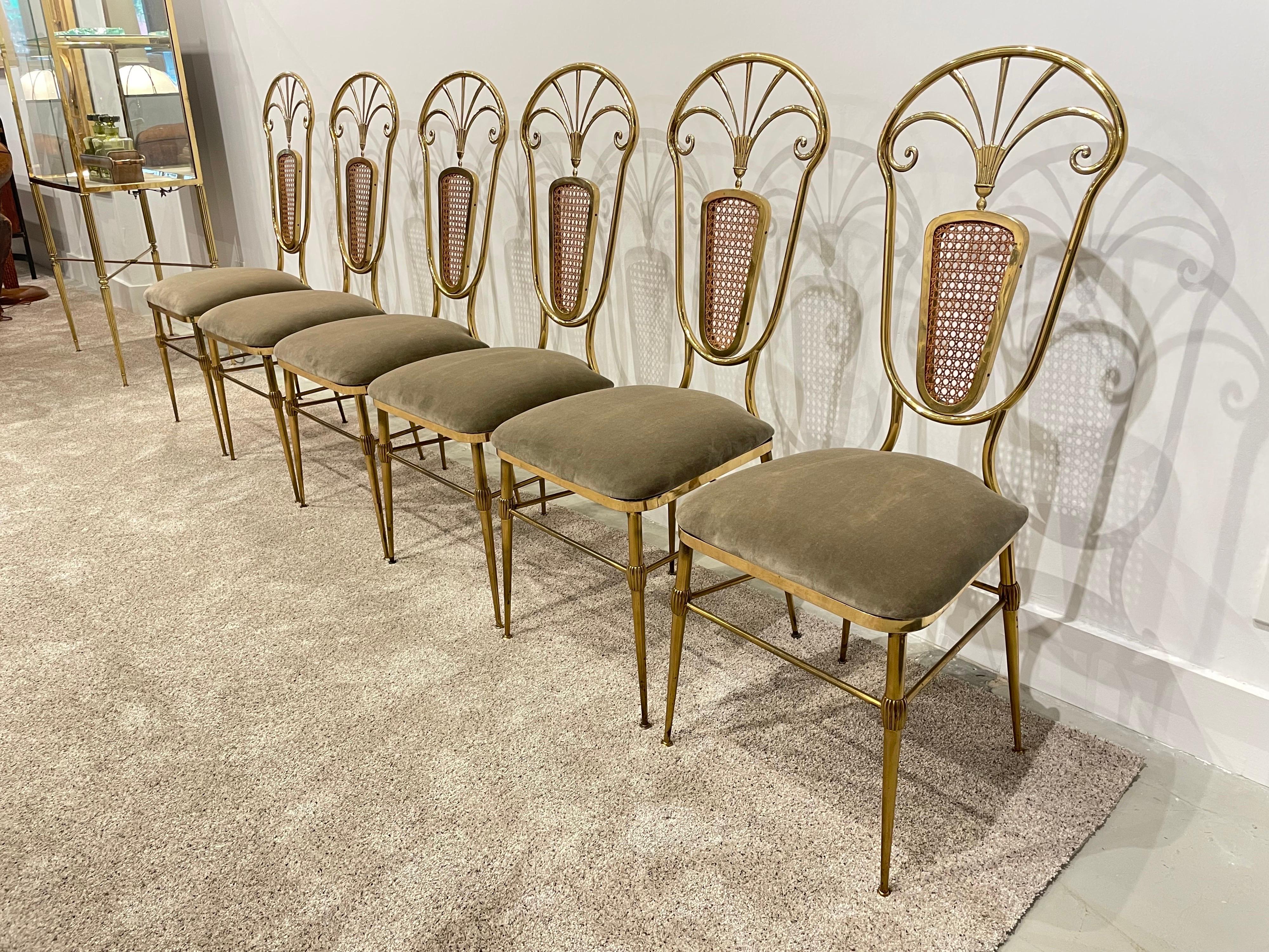 Wonderful brass dining chairs with wicker mesh accent to backrest and lovely details to legs and throughout. Newly upholstered in a mohair velvet fabric. Sold as a set of 6. Marked 