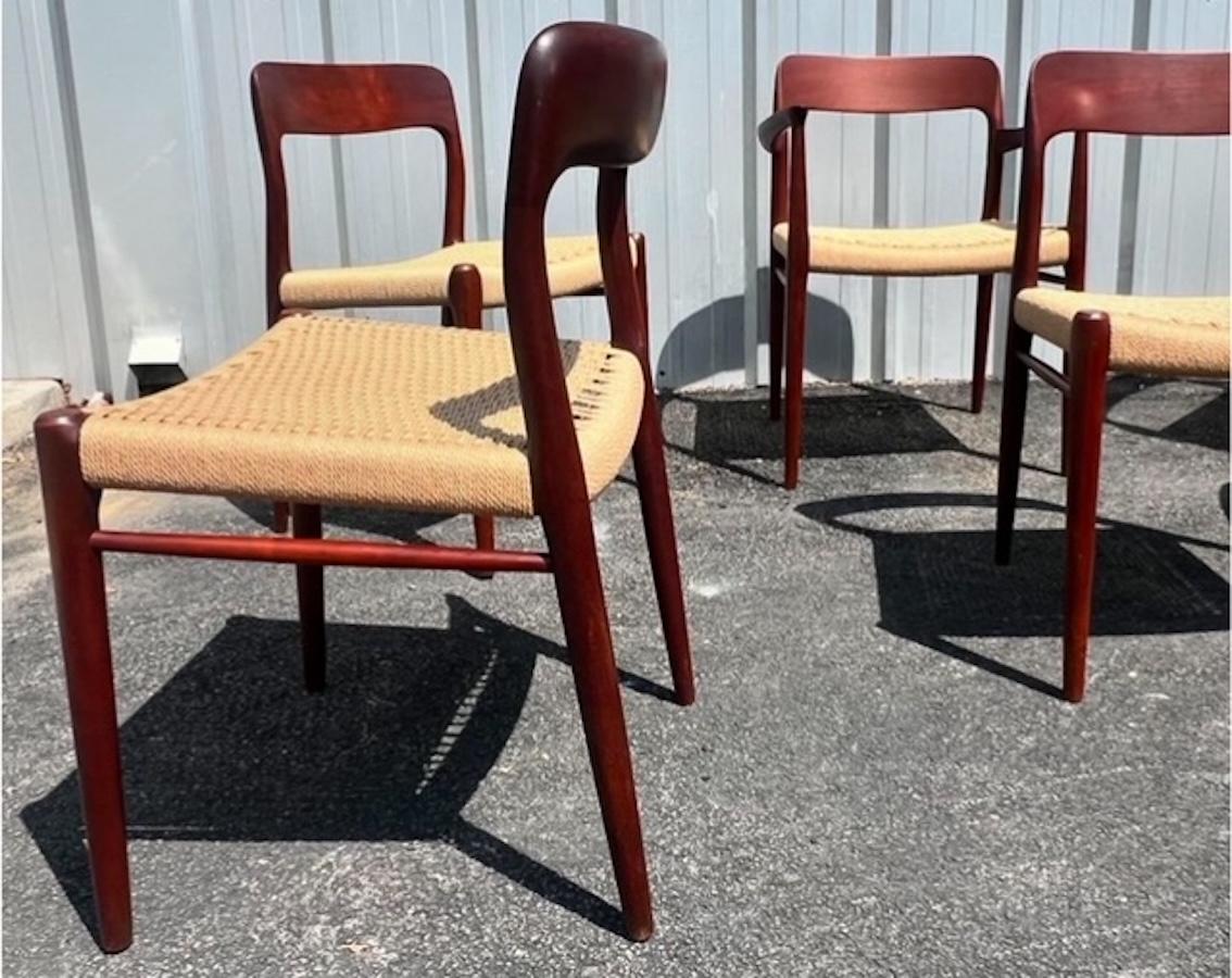 Set of 6 classic Danish Modern dining chairs Model 75 by Niels Otto Møller for J.L. Møllers Møbelfabrik made of teak with newly corded seats. Two armchairs or captain chairs. 

Dimensions: 21.5