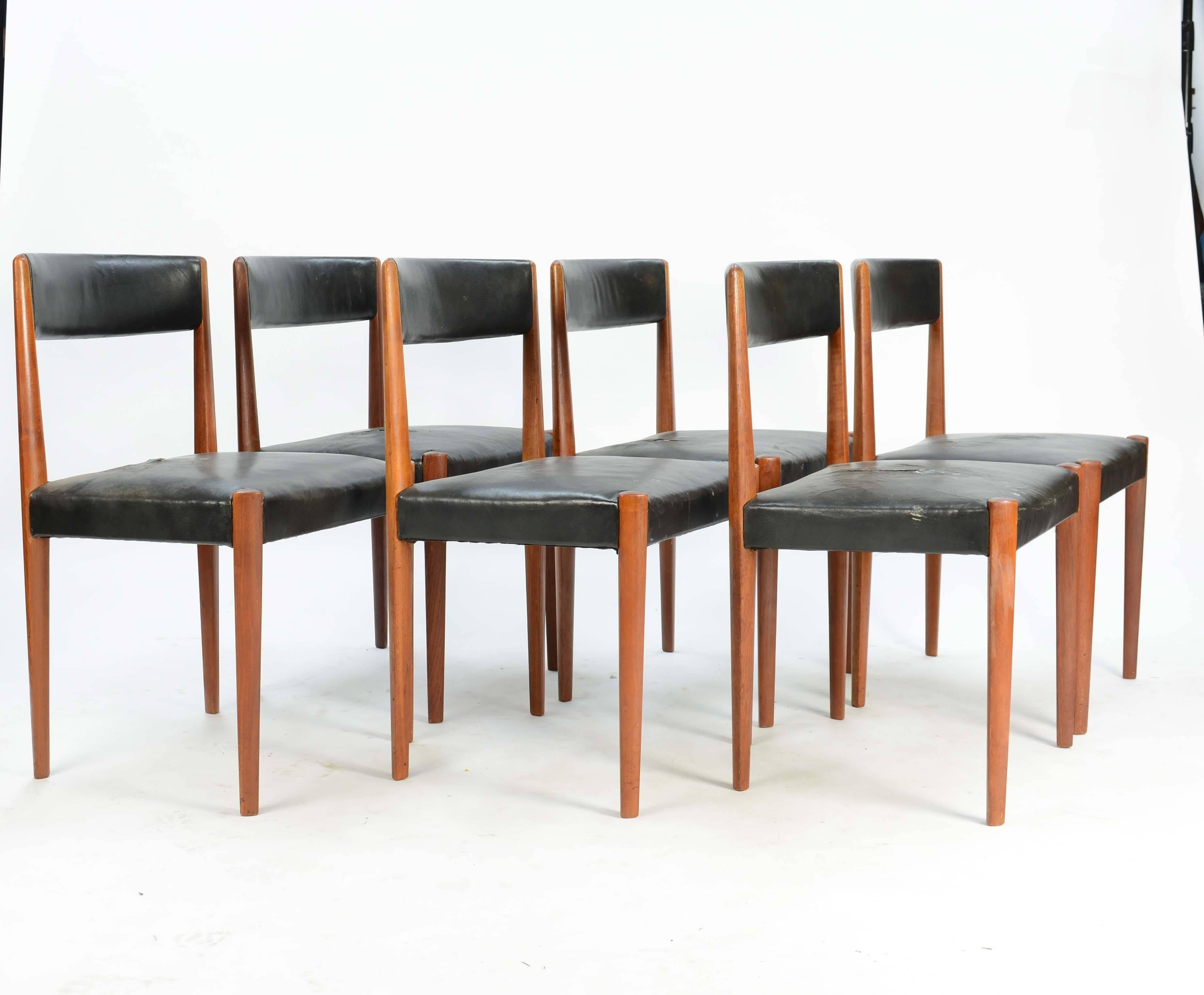 A set of six sculpted dining chairs by Aage Christensen for Fritz Hansen that features the sculpted diamond legs and distressed leather seat. These chair are elegant and understated in their refinement. These are Fritz Hansen model 4112.