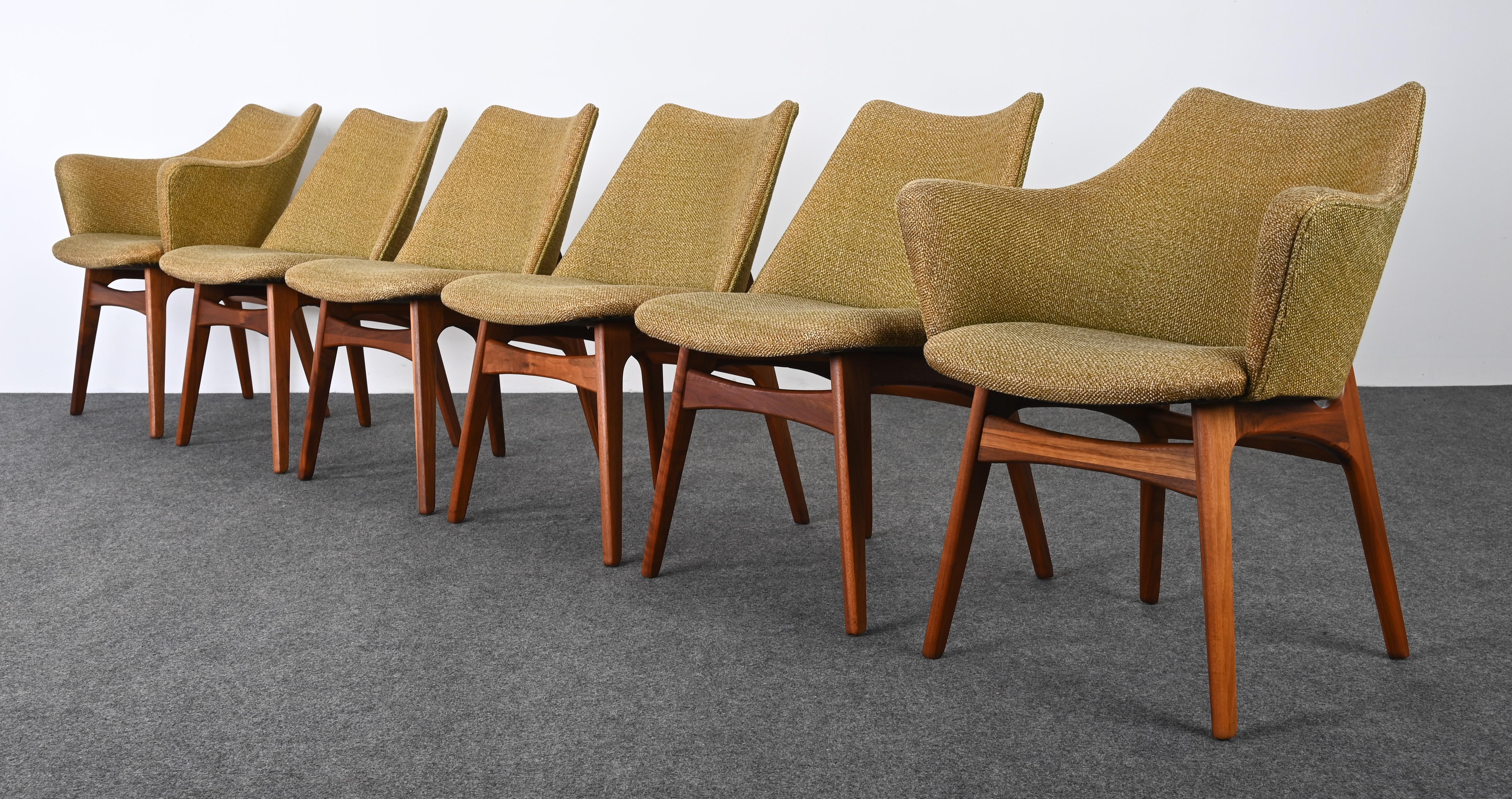 A sculptural Mid-Century Modern set of six dining chairs by Adrian Pearsall. This amazing set of chairs represents form and function. The accented structure of the leg on Model 2416-C is absolutely stunning. The chairs are made of walnut wood and