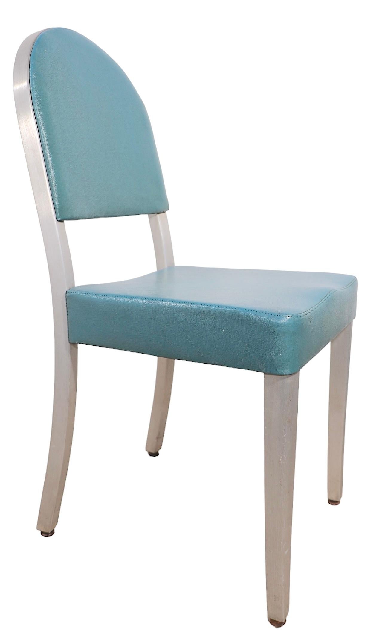 Chic set of six cafe style dining chairs made by GoodForm, General Fireproofing. The chairs feature aluminum frames, with turquoise  vinyl upholstered seats and backrests. All are solid and sturdy, some show wear and minor rips to the vinyl seats.