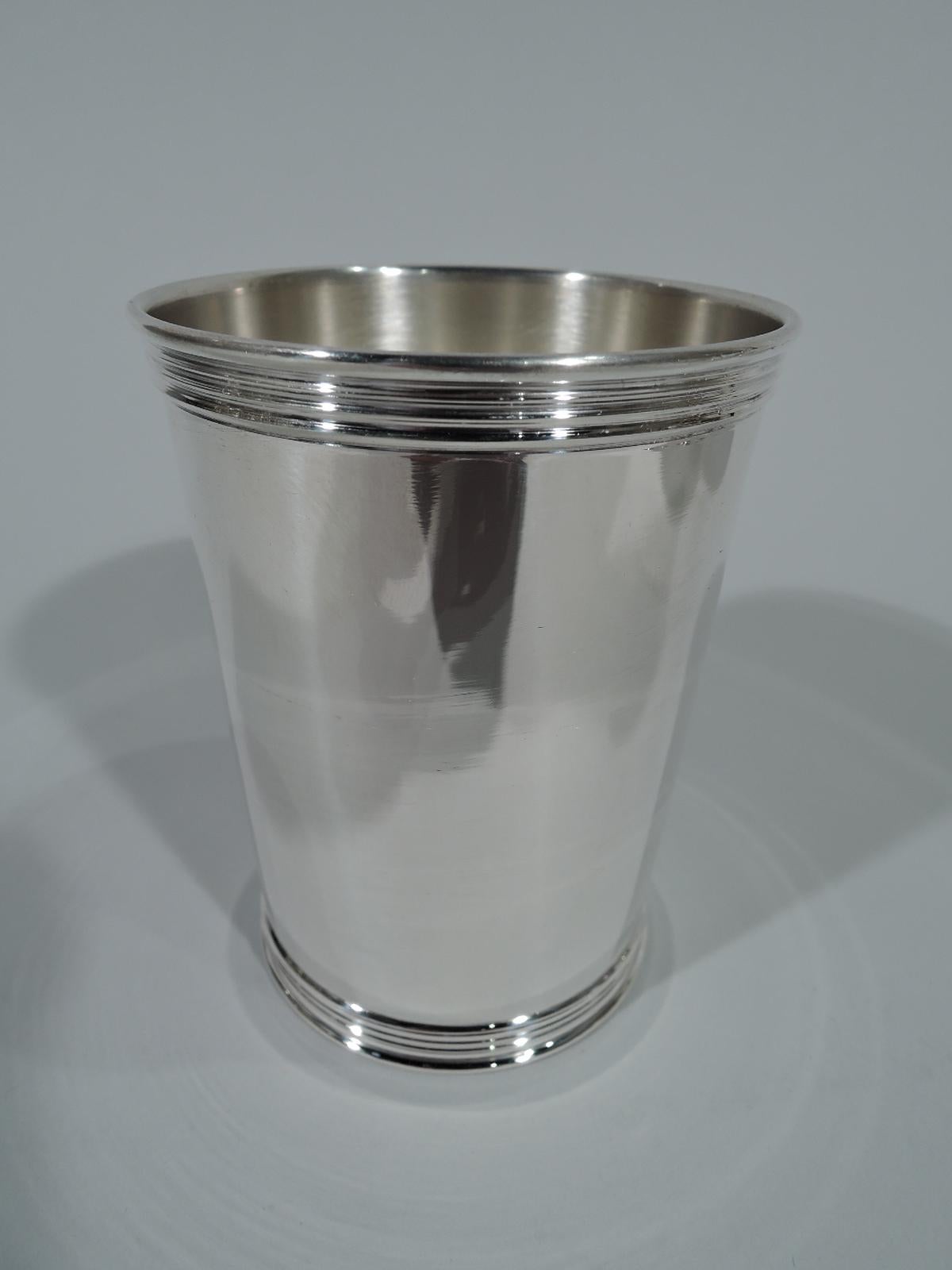 Set of six American sterling silver mint julep cups. Each: Straight and tapering sides and reeded rims. On underside is engraved a stylish presentation honoring so many years of loyal service with Brown-Forman, a Kentucky spirits maker. The