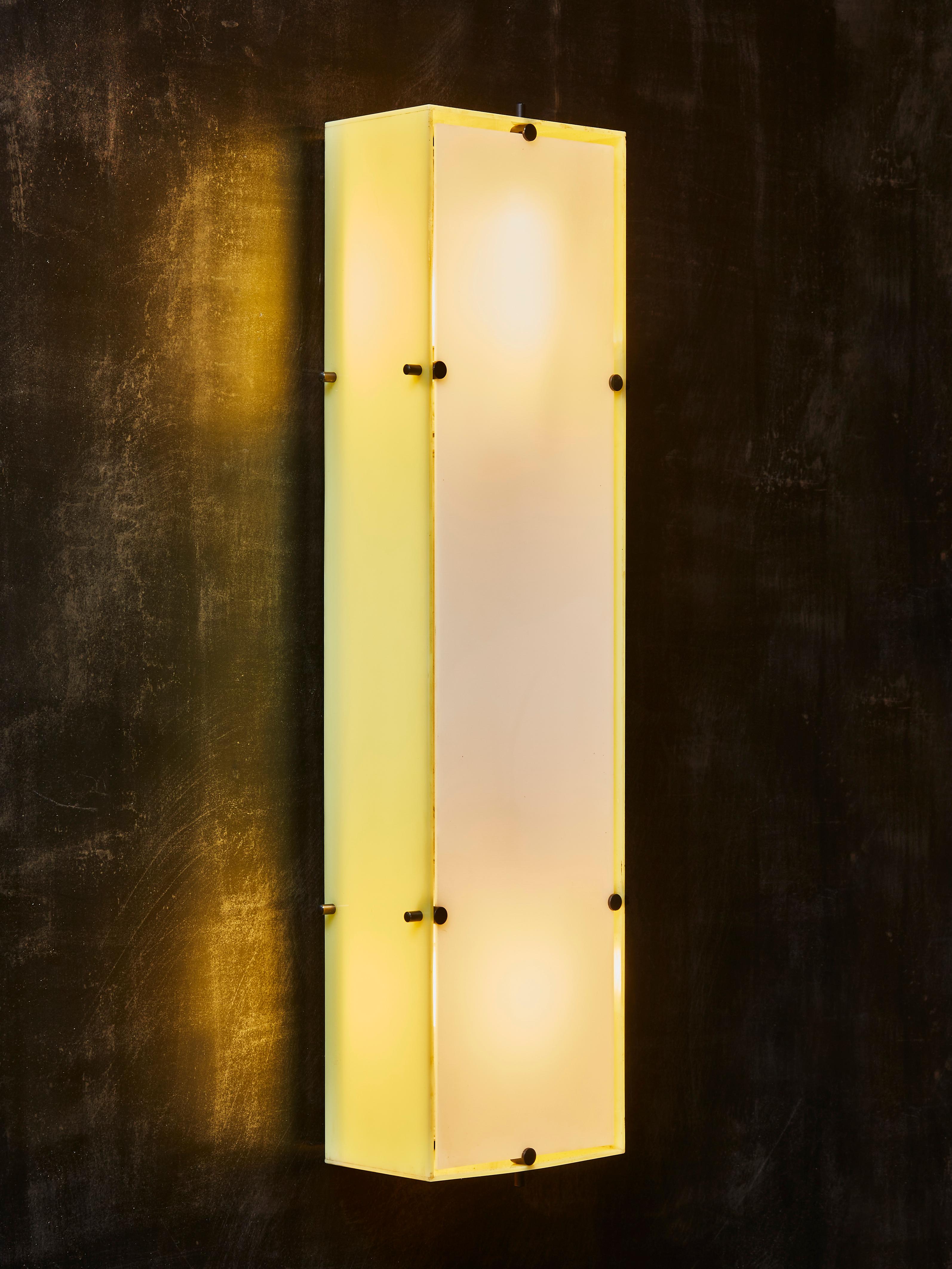 Pair of wall sconces made by Arredoluce and designed by Angelo Lelii, circa 1956.

Aluminium backplate with yellow plexi sides and white plexi front.

Set screws in painted brass

Original stickers.


Originally a set of six, only a pair is still