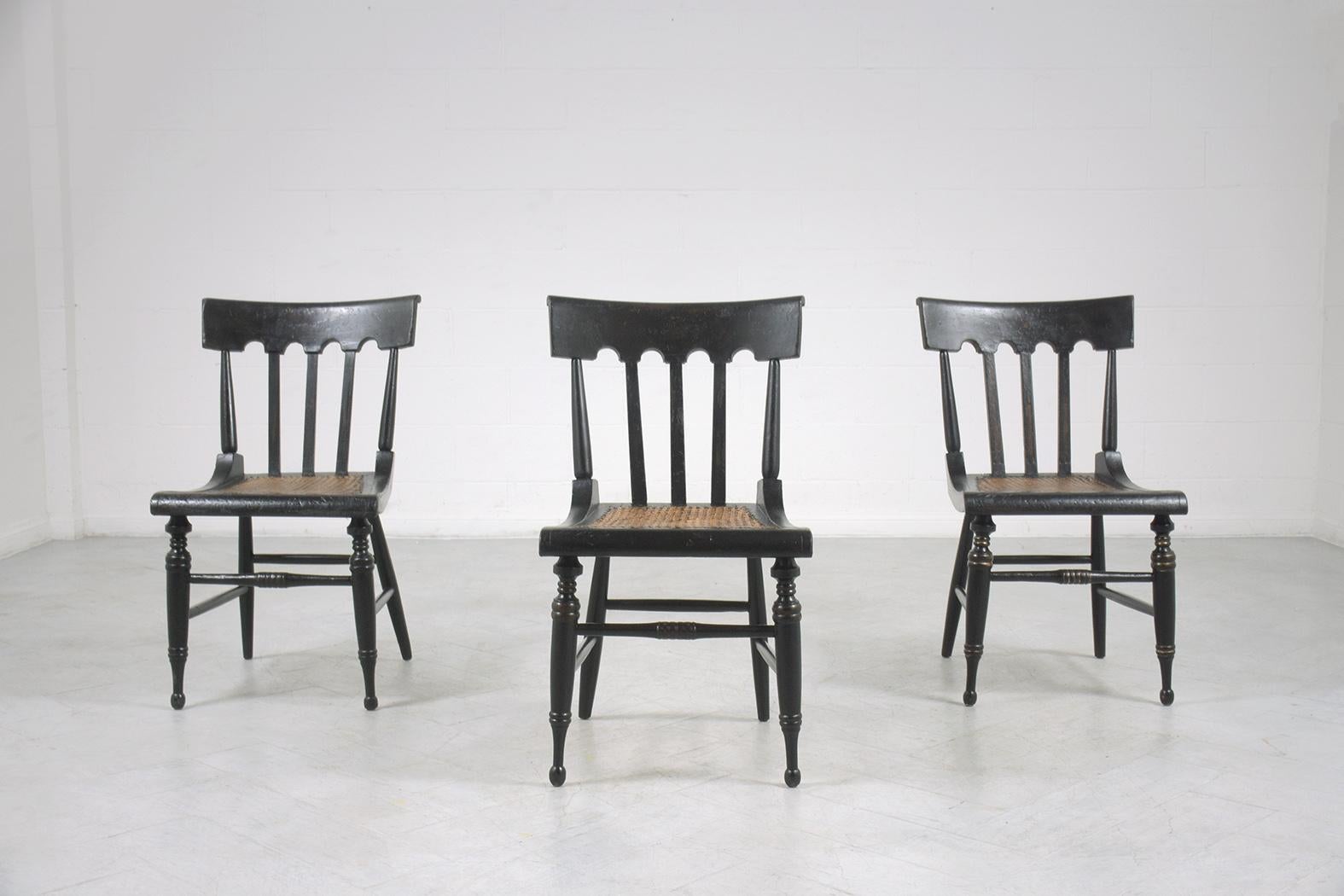 An extraordinary set of six dining chairs is hand-crafted out of wood and has been newly restored by our team of expert craftsmen. This fabulous set of antique dining chairs features curved back stretched legs painted in ebonized color caning seats
