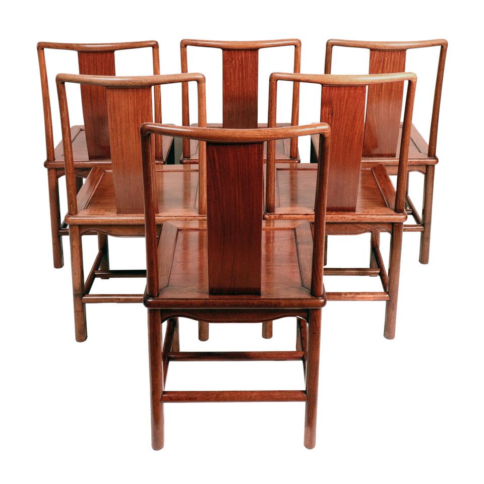 A set of six Chinese Mid-Century Modern dining chairs, Hong Kong 1970s, a Western-influenced modification to the Classic Chinese splat back chair. Classic mortise and tenon joinery construction with center floating seat panel, all carved of an